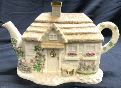 LENOX The Irish Blessing Porcelain Teapot W Lid: Underside reads LENOX THE IRISH BLESSING TEAPOT. Teapot is porcelain. Piece has cottage form. Teapot includes lid. Lid has chimney form with gilt rim. Piece measures approximately 9.5 inches deep