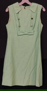 Vintage Handmade Green Dress W/ Bow Accent: Vintage Handmade Green Toned Dress W/ Bow & Bejeweled Button Accent. Zipper to the reverse. Measured flat approx. 35 inches in length. Width across chest measured flat approx. 14 inches in width.