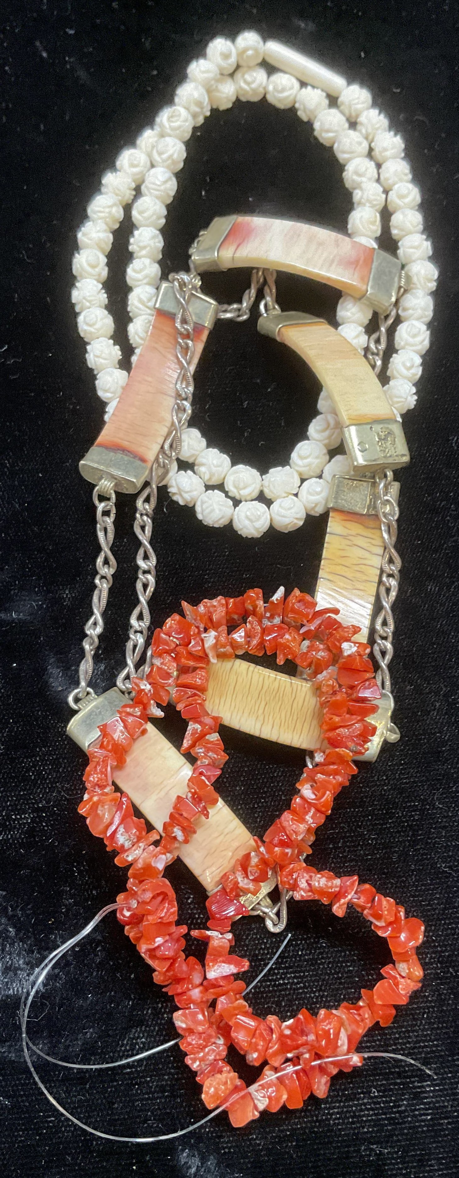 Lot 3 Red Coral & Bone Beaded Necklaces: Lot of 3 necklace. Red coral chipped beaded necklace, silver tone necklace with bone pendants, carved white flower beaded necklace, appears to be bone. Longest drop length approx 11 inches. Some wear