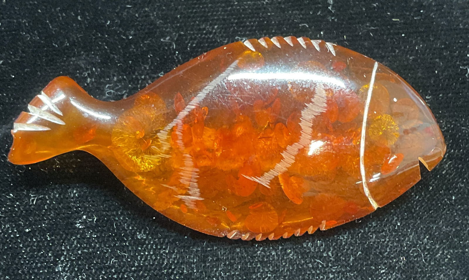 Vintage Carved Amber Lucite Fish Brooch: Vintage carved amber lucite fish brooch. Hinge pin on underside. Measures approx 1 x 2.5 inches. Some wear including scratching observed. Jewelry, estate jewelry, costume jewelry, cocktail jewelry, Fa