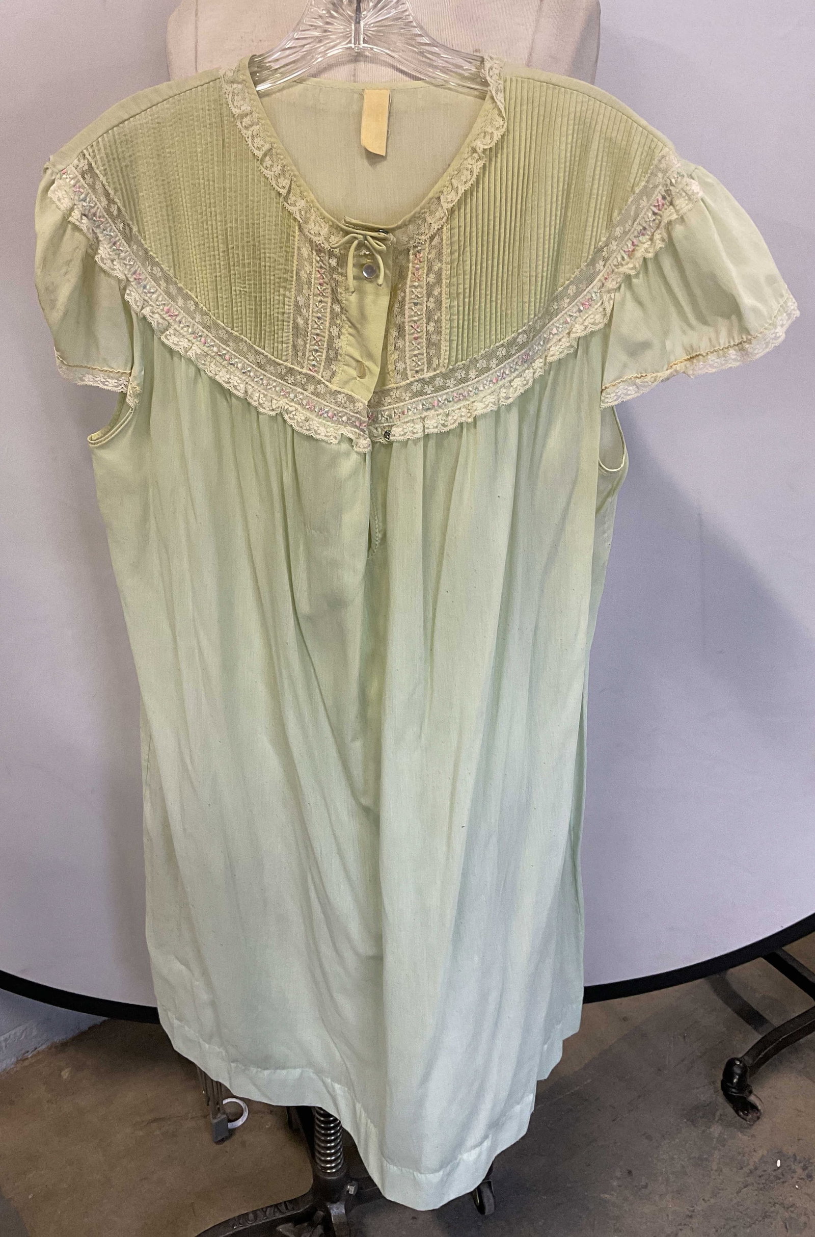 Vintage Green Cotton Nightgown: Vintage green nightgown. Pleated yoke with lace trim and floral embroidery. Measures approx 19.5 inches across chest. Wear to material including blemishes observed, one button needs repair. Nightgown,
