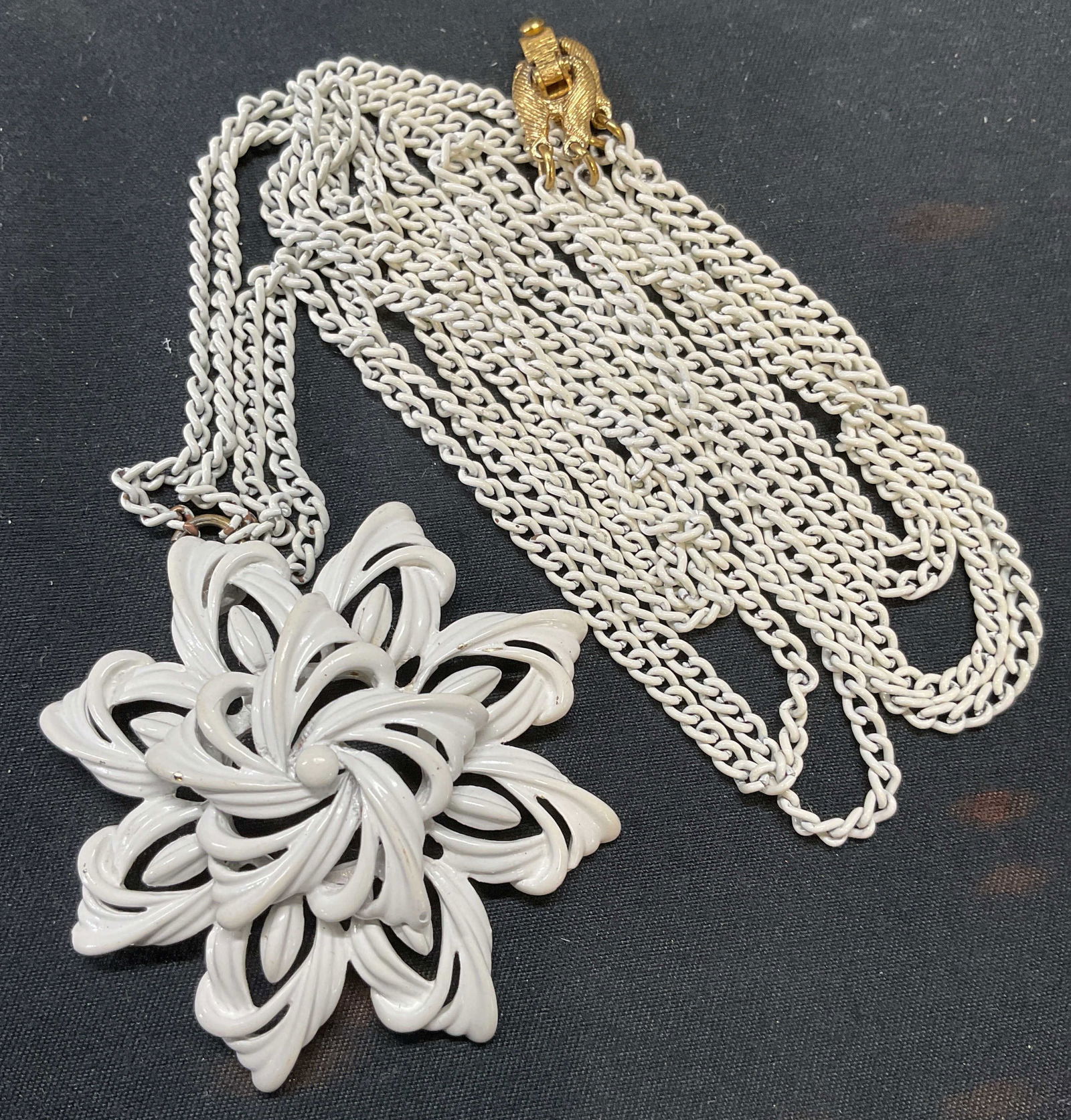Vintage Monet White Enamel Flower Necklace: Vintage Monet white enamel double chain necklace with flower pendant. Signed on clasp. Drop length approx. 15 inches. Pendant measures approx. 2 inches wide. Some surface wear including scratching obs