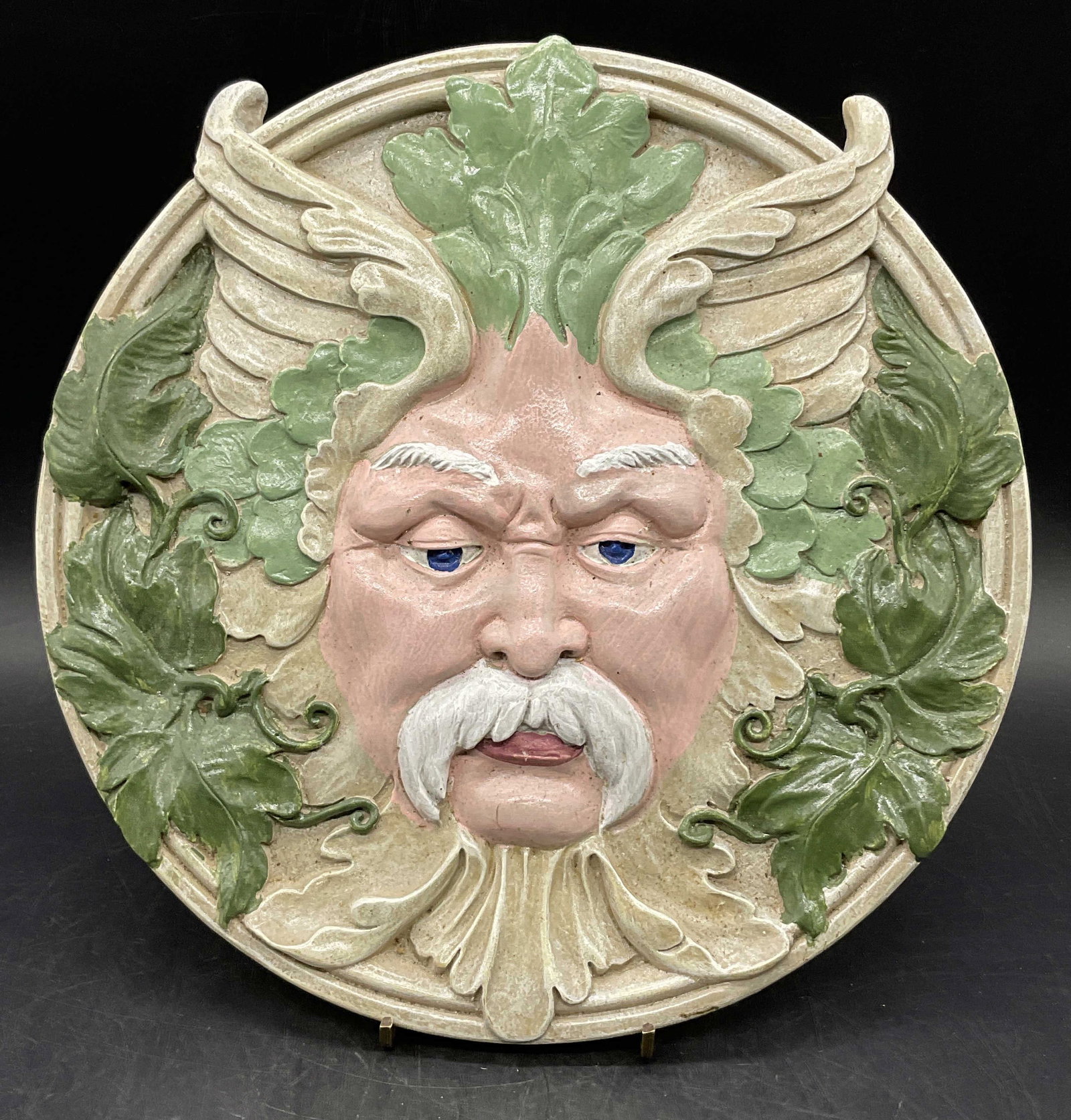 Bacchus / Dionysus Figural Round Wall Plaque: Bacchus / Dionysus Figural Round Wall Plaque. Dionysus, the Greek god of wine, theatre, and fertility, also known as Bacchus in Roman mythology. Depicted as a wall plaque encircled by grape leaves and