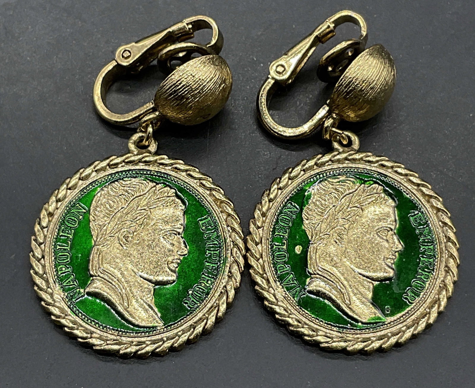TRIFARI Vintage Enamel Currency Motif Earrings: TRIFARI Vintage Enamel Currency Motif Earrings. Clip on earrings. Signed TRIFARI to reverse. Measures approx. 1.5L x 1W in. Surface wear and discoloration present. Vintage jewelry, Vintage accessories