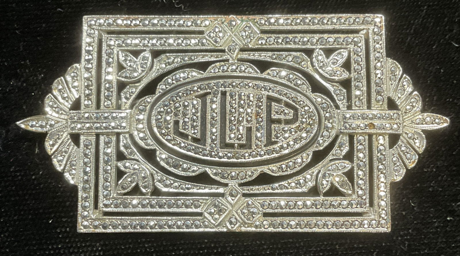 Art Deco Sterling Silver Marcasite Brooch: Art deco sterling silver brooch with monogram JLP. Marcasite decoration. Marked sterling. Measures approx 1 3/8 x 2.5 inches. Total weight 20.0 grams. Some wear including scratching observed. One marc