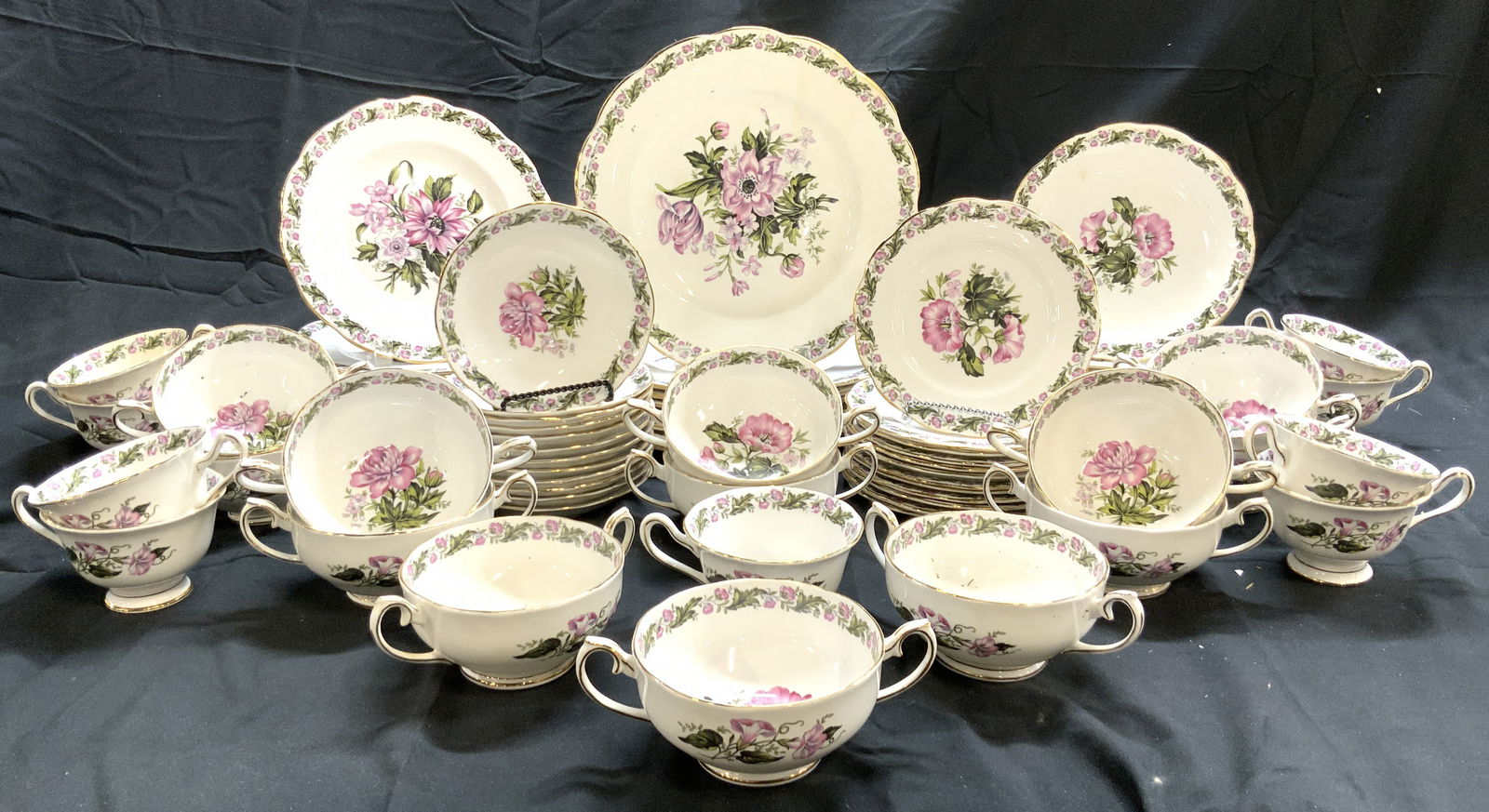 ROYAL ALBERT COTSWOLD 78 Porcelain Set England: Undersides are marked ROYAL ALBERT COTSWOLD BONE CHINA ENGLAND. Each piece is white with multi toned floral and leaf detail. Each piece has gilt rims. Lot includes 13 dessert bowls, 12 bread plates, 1