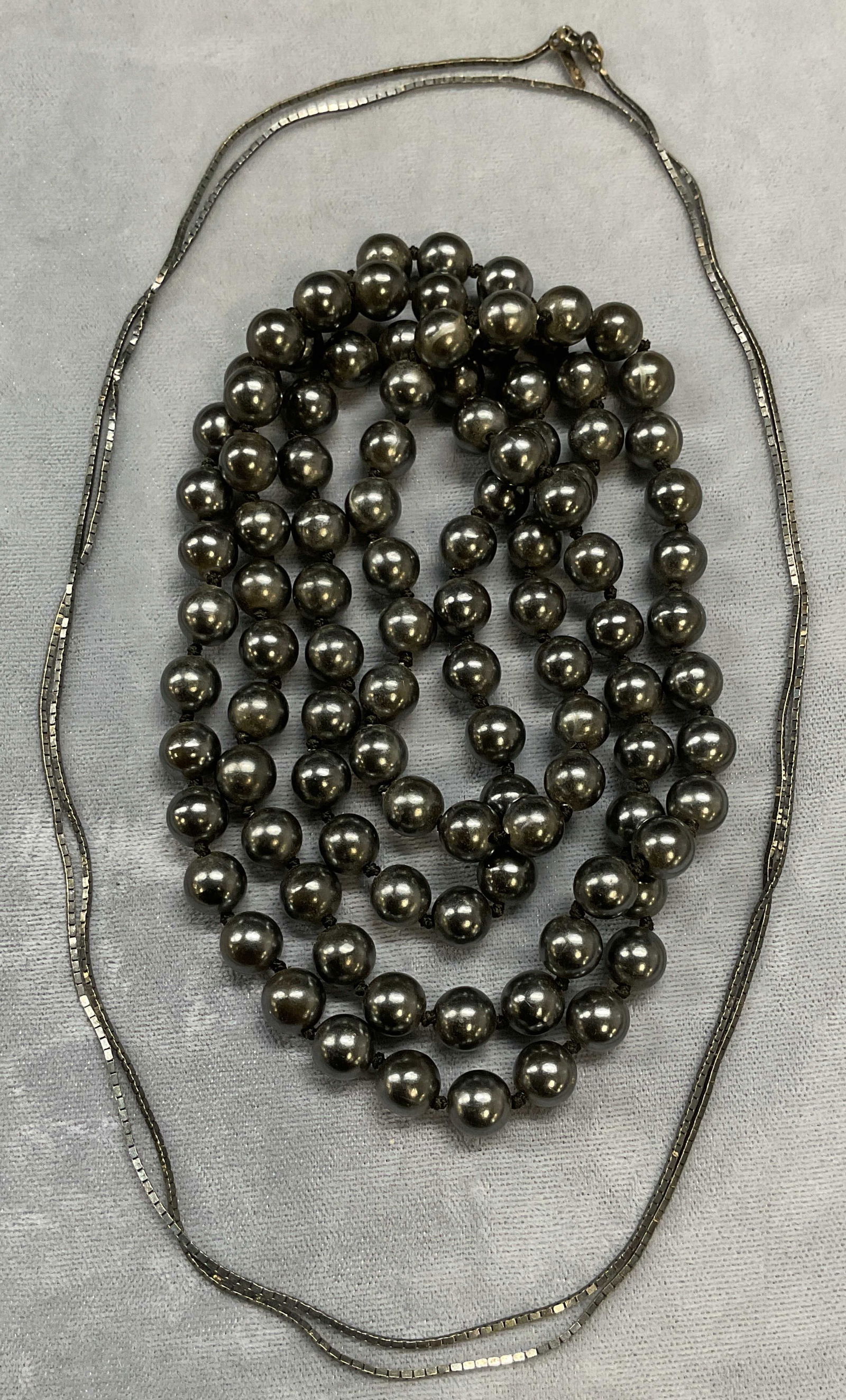 Lot 2 Sterling Silver & Faux Pearl Necklaces: Lot of 2 necklaces. Vintage sterling silver chain necklace d. Marked sterling. Drop length approx 17.5 inches, total weight .19 ozt. Faux Tahitian pearl beaded necklace. Drop length approx 18 inches.
