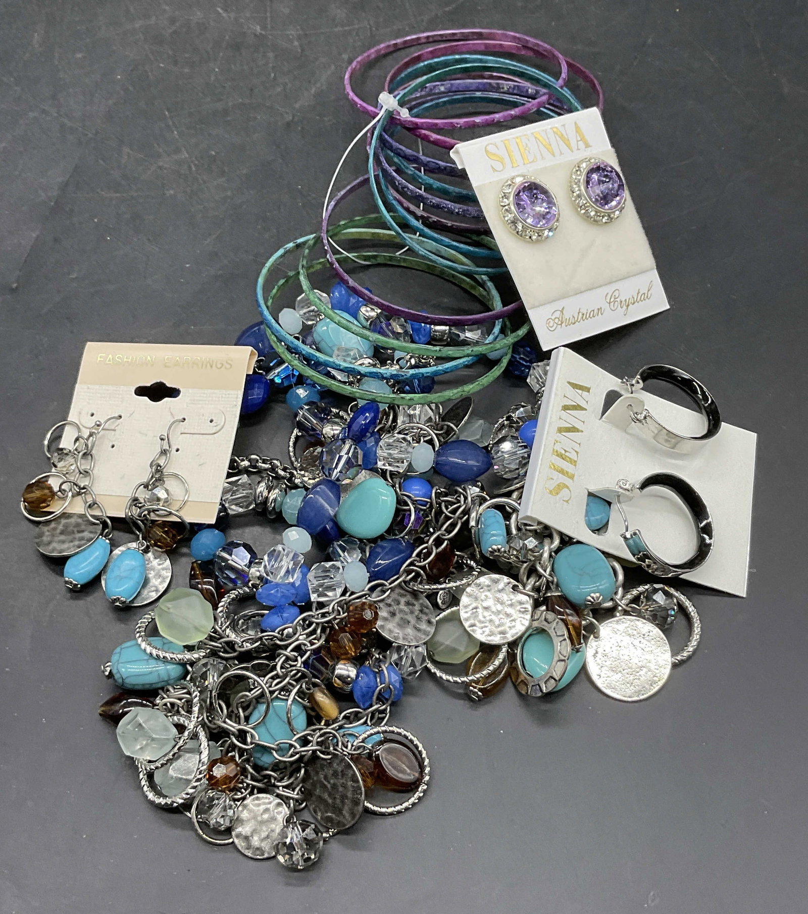 Group Lot Jewelry Earrings, Bracelets & Necklaces: Group Lot Jewelry Earrings, Bracelets & Necklaces. Earrings are affixed to packaging which reads SIENNA or FASHION EARRINGS. Bracelet diameter approx. 2.75 inches. Pieces are crafted from metal, faux 