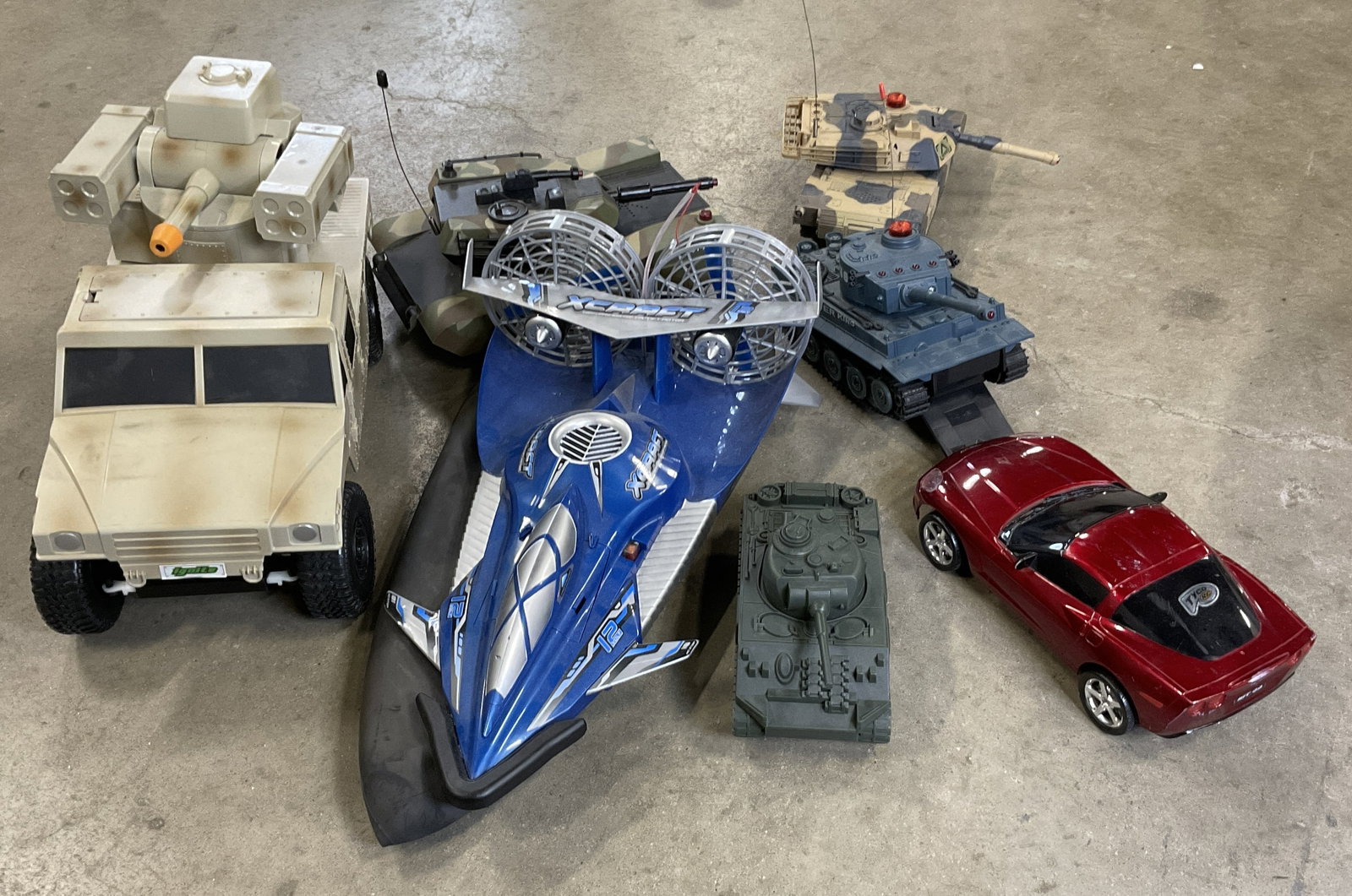 Lot 7 Tank, Car, Automobile Toys, XCRAFT +: Seven tank, car, and automobile toys. One piece is marked XCRAFT. The toys are crafted from composite and metal parts. Largest measures approx. 9.25H x 15W in. Not tested for function. Some appear to 
