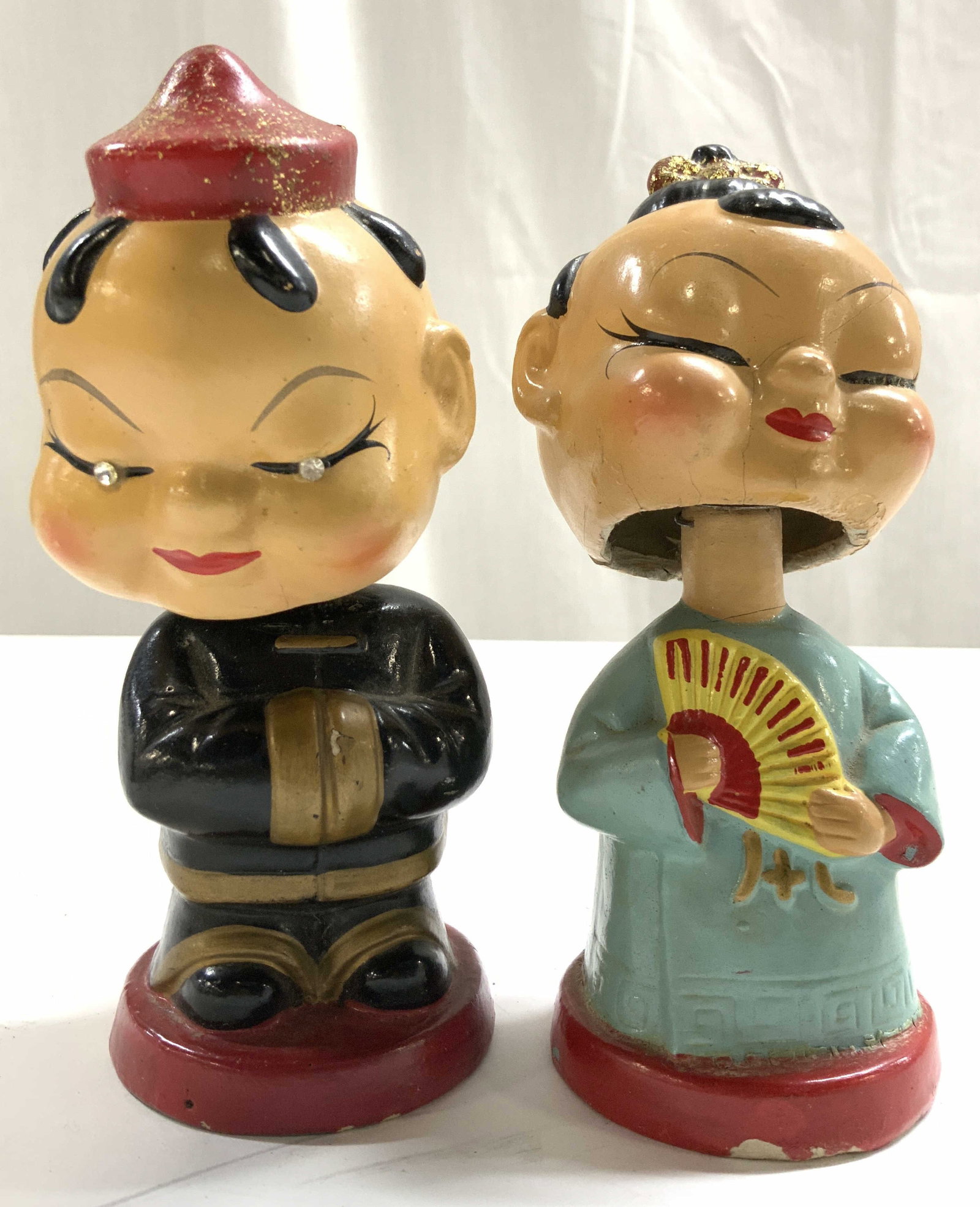 Lot 2 Vintage Hand Painted Asian Bobbleheads: Lot includes 2 Bobbleheads. Appears to be composite. Each are vintage. Each piece appears to be hand painted. Includes 1 male and 1 female figure. Each measures approximately 5.5 inches tall 2.5 inche