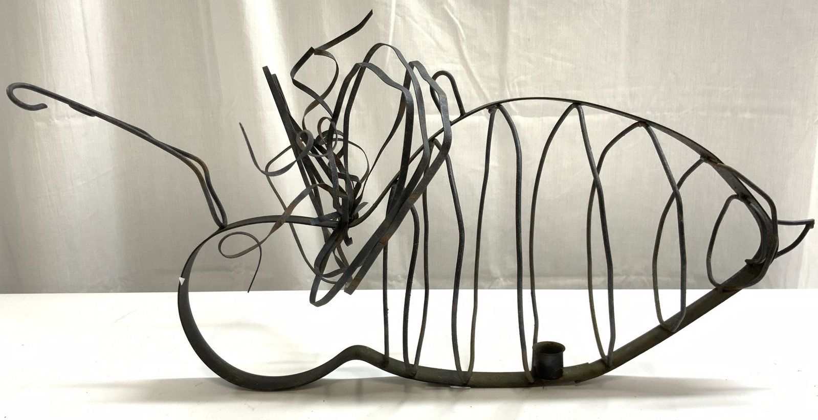 Vintage Hanging Metal Bumblebee Candle Holder: Candle holder is vintage. Piece is black toned and metal. Candleholder has bumblebee form. Piece has 1 candle area. Structure on top to hang. Piece measures approximately 24 inches long 12 inches tall