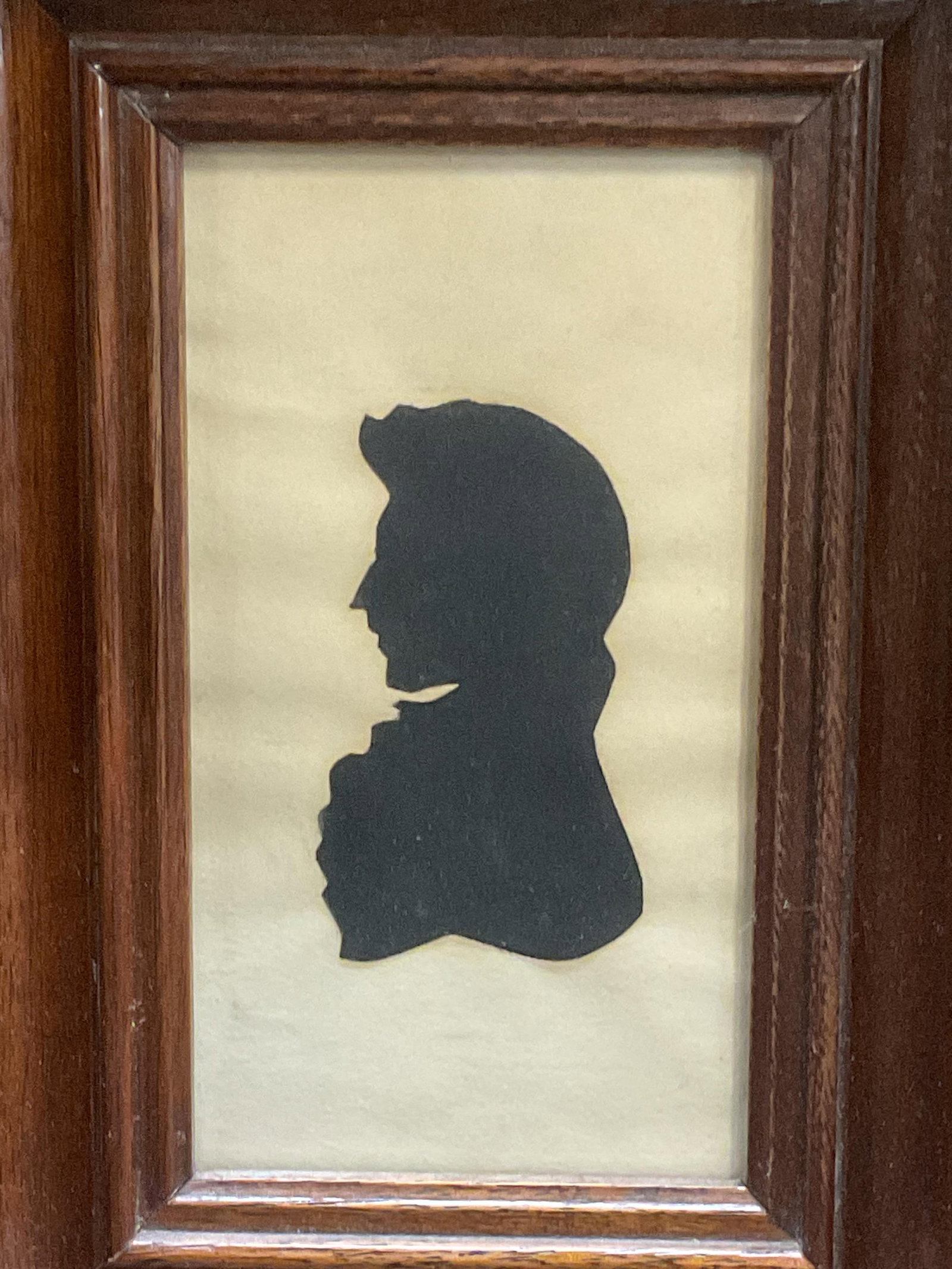 Framed Folk Art Cut Out Silhouette, Man: Framed folk art silhouette. Black paper cutout on white paper. Bust of a man. Framed in wood frame. Not examined out frame. Frame measures approx 8 x 6 inches. Some wear consistent with exposure. Art,