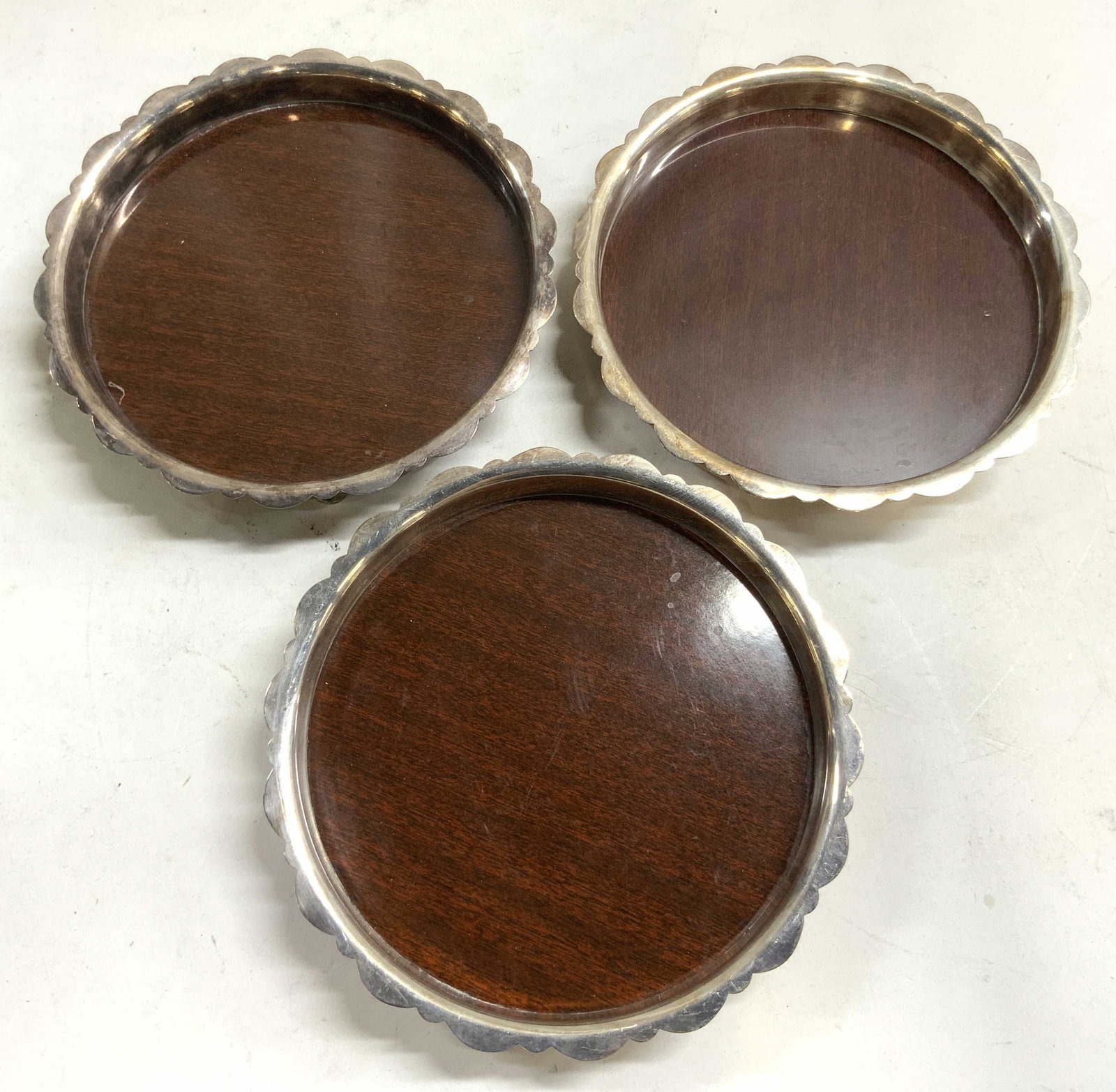 CRESCENT Vtg Silver Plate Lot 3 Wine Coasters: Undersides are inscribed CRESCENT. Lot includes 3 wine coasters each have silver plate frames, each with 3 feet. Each appear to be vintage. Coasters each have circular forms with raised edges. Centers