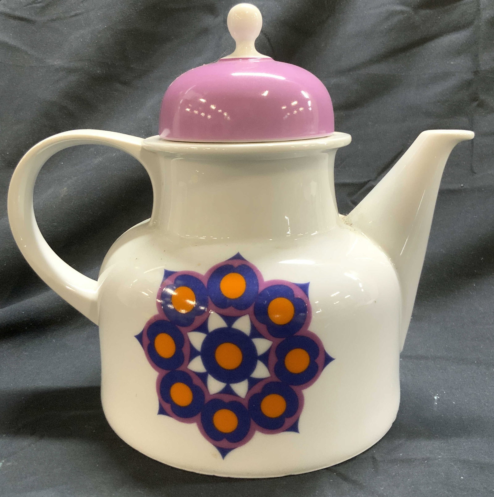 Vintage Porcelain Teapot W Floral Detail & Lid: Teapot is vintage. Piece is porcelain. Teapot has multi toned floral detail. Piece is white with purple toned lid. Teapot measures approx 8.5 inches deep 8 inches tall, 5.5 inches wide. Teapot, porcel