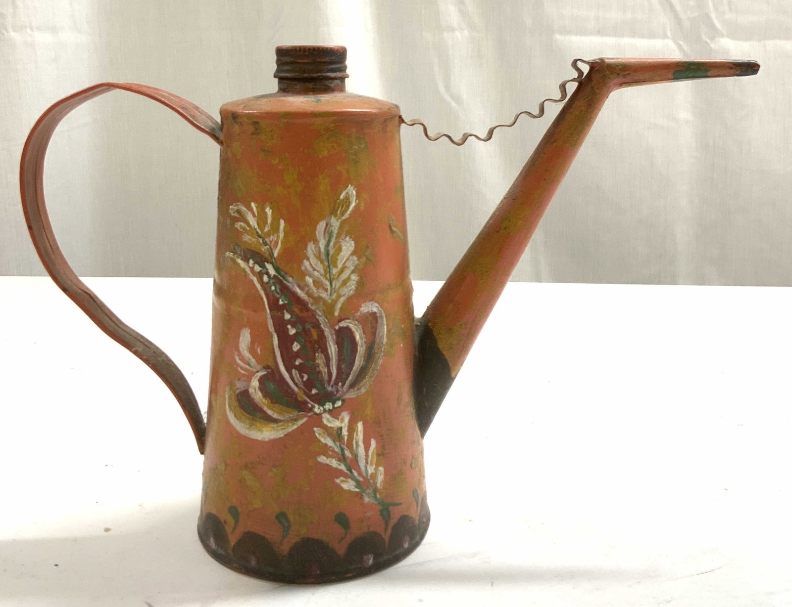 Vintage Hand Painted Metal Teapot W Lid: Teapot is vintage. Piece is hand painted with multi toned floral and leaf detail. Teapot includes lid. Piece has uniquely formed spout. Teapot measures approx 9 inches deep 6 inches tall 3 inches wide