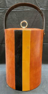 Brown Faux Leather Striped Ice Bucket: Brown faux leather ice bucket with tan and black striped design. Measures approx 7.5 x 11 inches. Some wear including scratching observed. Ice bucket, faux leather ice bucket, striped ice bucket,
