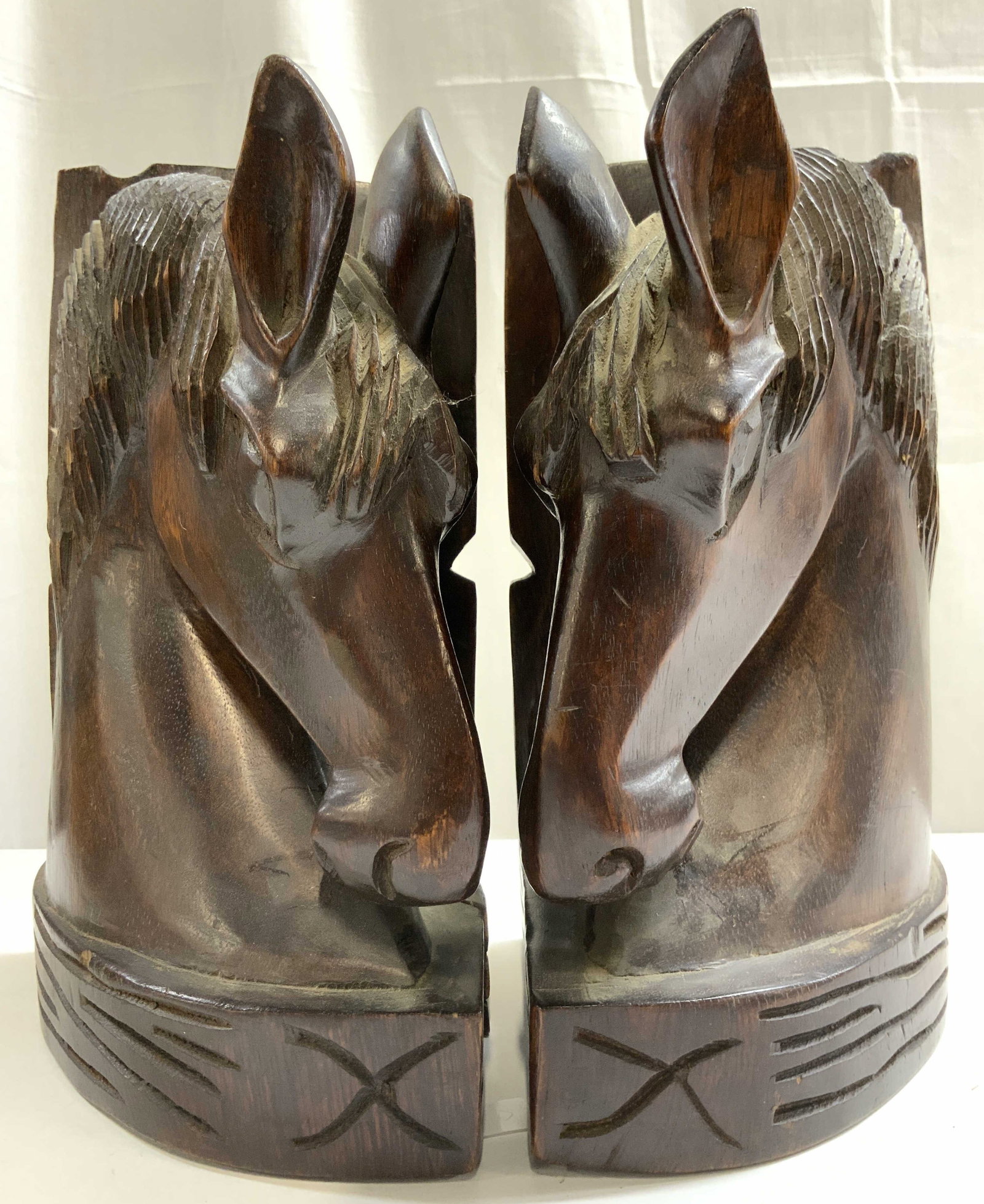 2 Rustic Western Crvd Wood Horsehead Bookends 10in: Bookends are brown toned and wooden. Rustic western style horsehead bookends. Each have carved relief detail to show facial features and horse mane. Bookends each measure approximately 10.5 inches tal