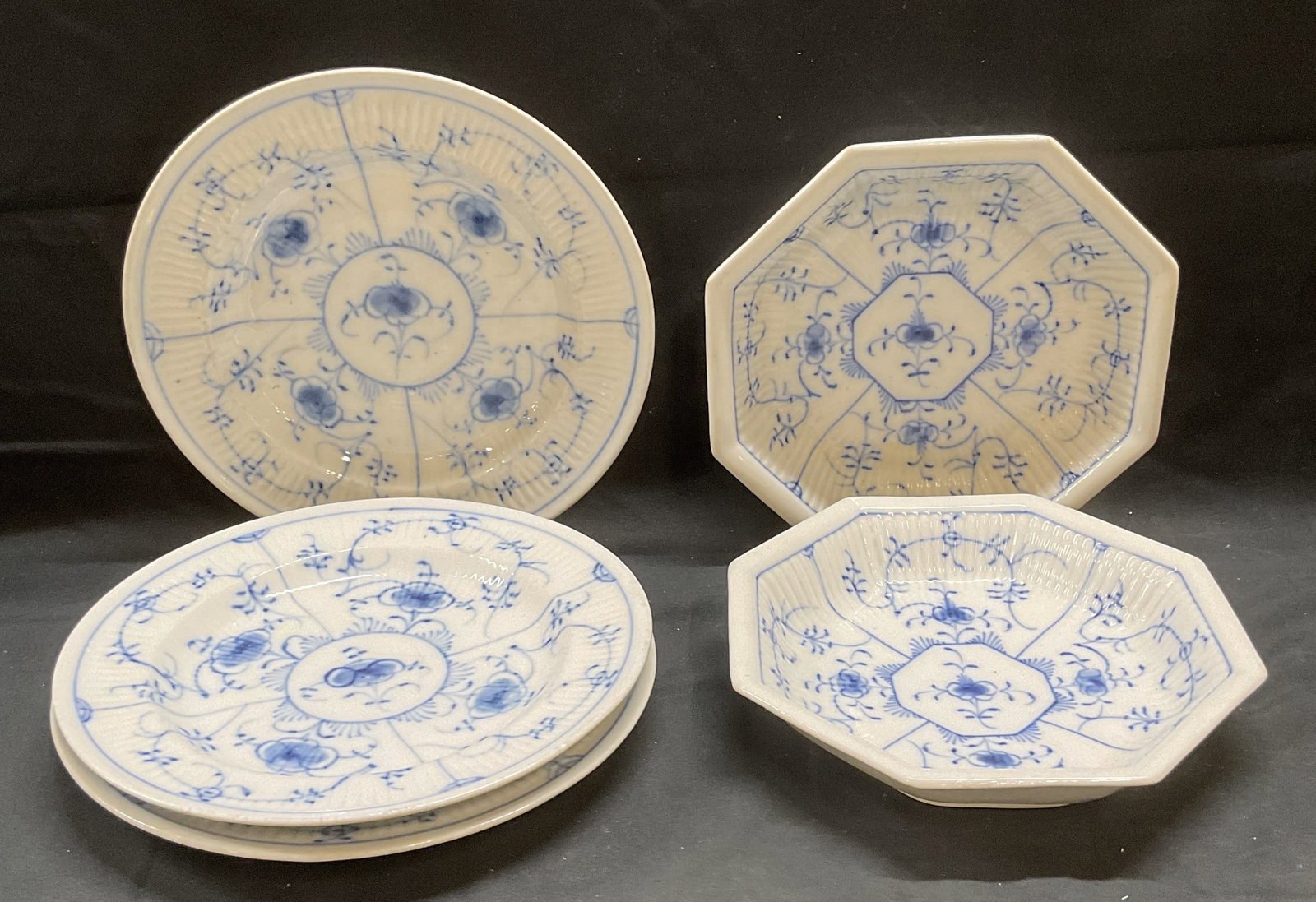 Set 5 Signed Blue Fluted Lace Porcelain Bowls: Set of 5 vintage porcelain bowls. Hexagonal and round shaped. Blue fluted lace floral designs. Signed on underside with X and S marks. Larger bowls measure approx 9 inches wide. All pieces have wear i