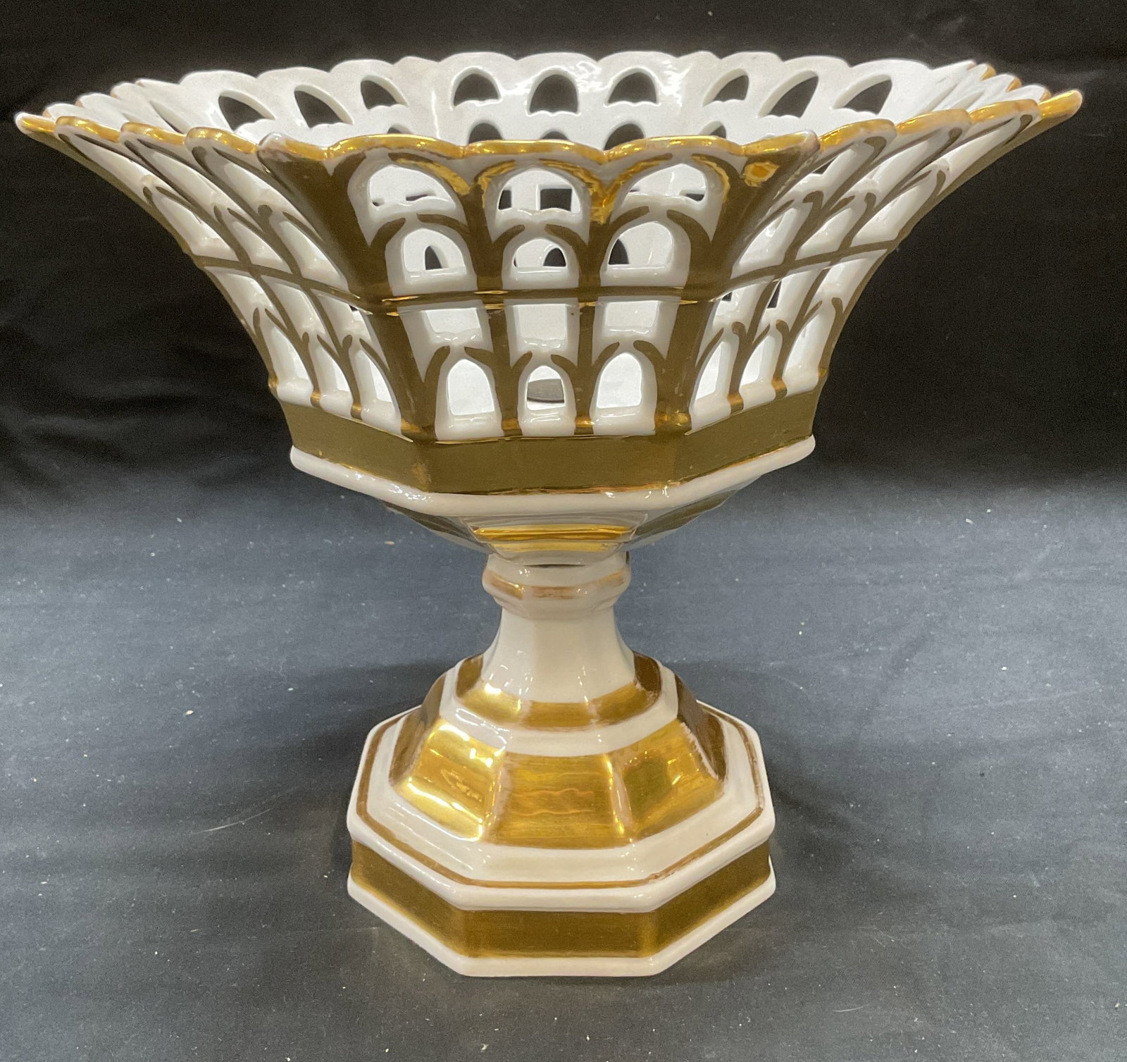 Vtg Gilt Porcelain Reticulated Corbeille Basket: Vintage gilt porcelain French Empire style reticulated Corbeille basket. Pedestal base. Fluted basket with scalloped rim. Measures approx 8.75 x 8 inches. Some wear including scratching and loss to pa