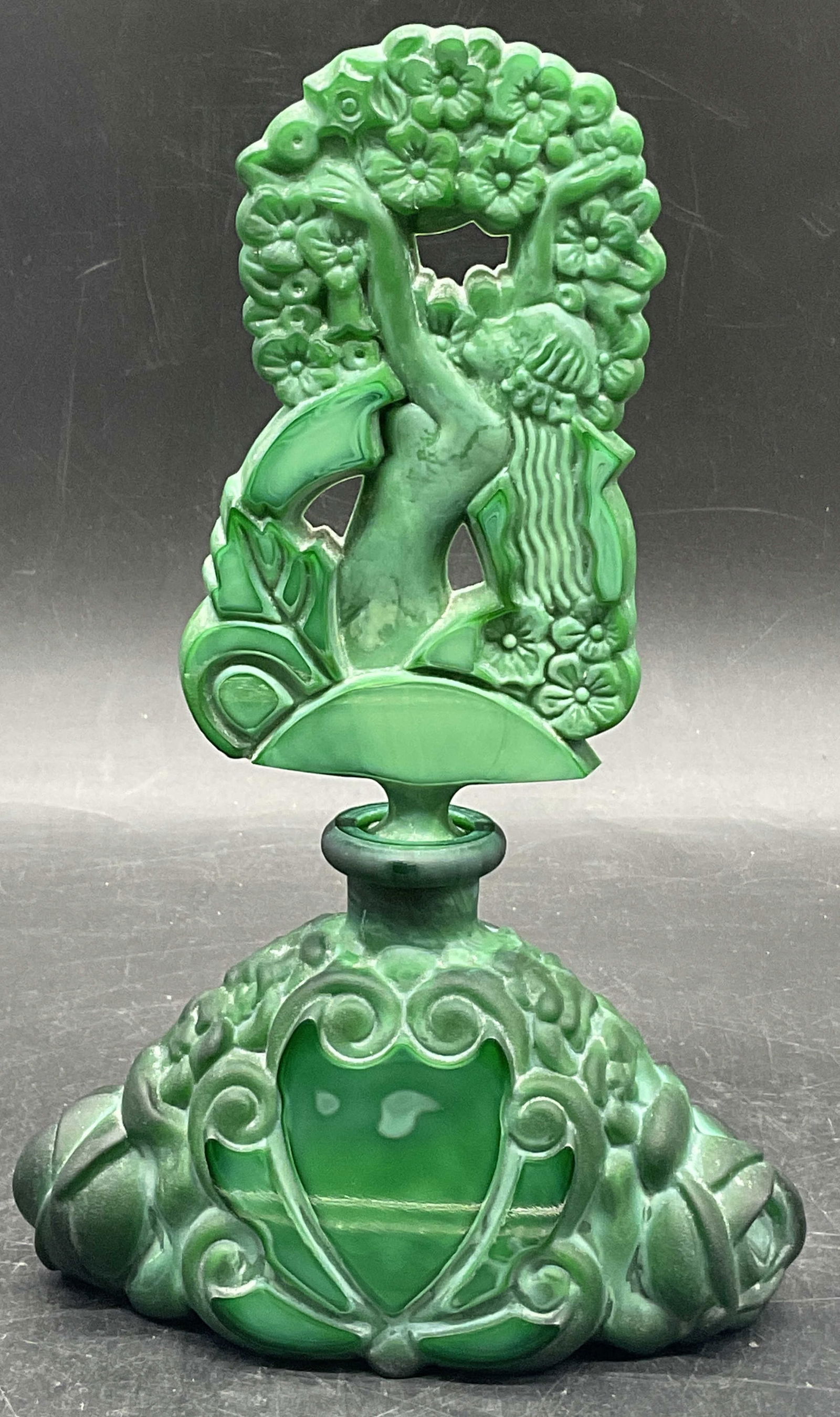 Vtg Art Nouveau Malachite Art Glass Perfume Bottle: Vintage Art Nouveau Malachite Art Glass Perfume Bottle. Partially nude female figural to the stopper. Figural is depicted reaching up into florals. Measures approx. 7.5H x 4.5W in. Polished and froste
