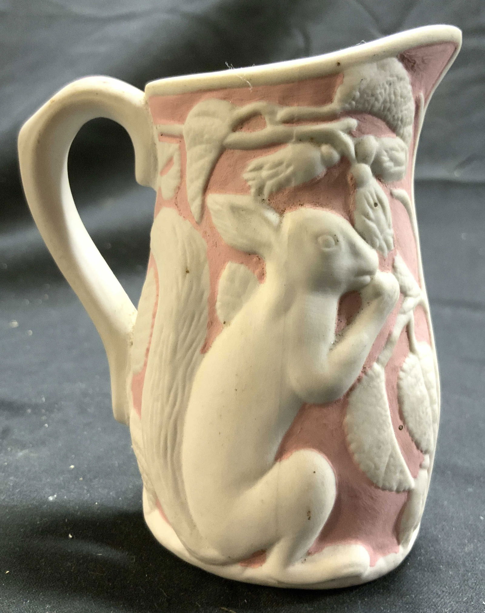 MMA Vtg Porcelain Creamer Dish Pink & White: Underside is inscribed MMA. Piece appears to be porcelain. Cream dish is pink and white with squirrel vine and leaf detail. Vessel measures approximately 3.25 inches deep 3.75 inches tall 2.25 inches