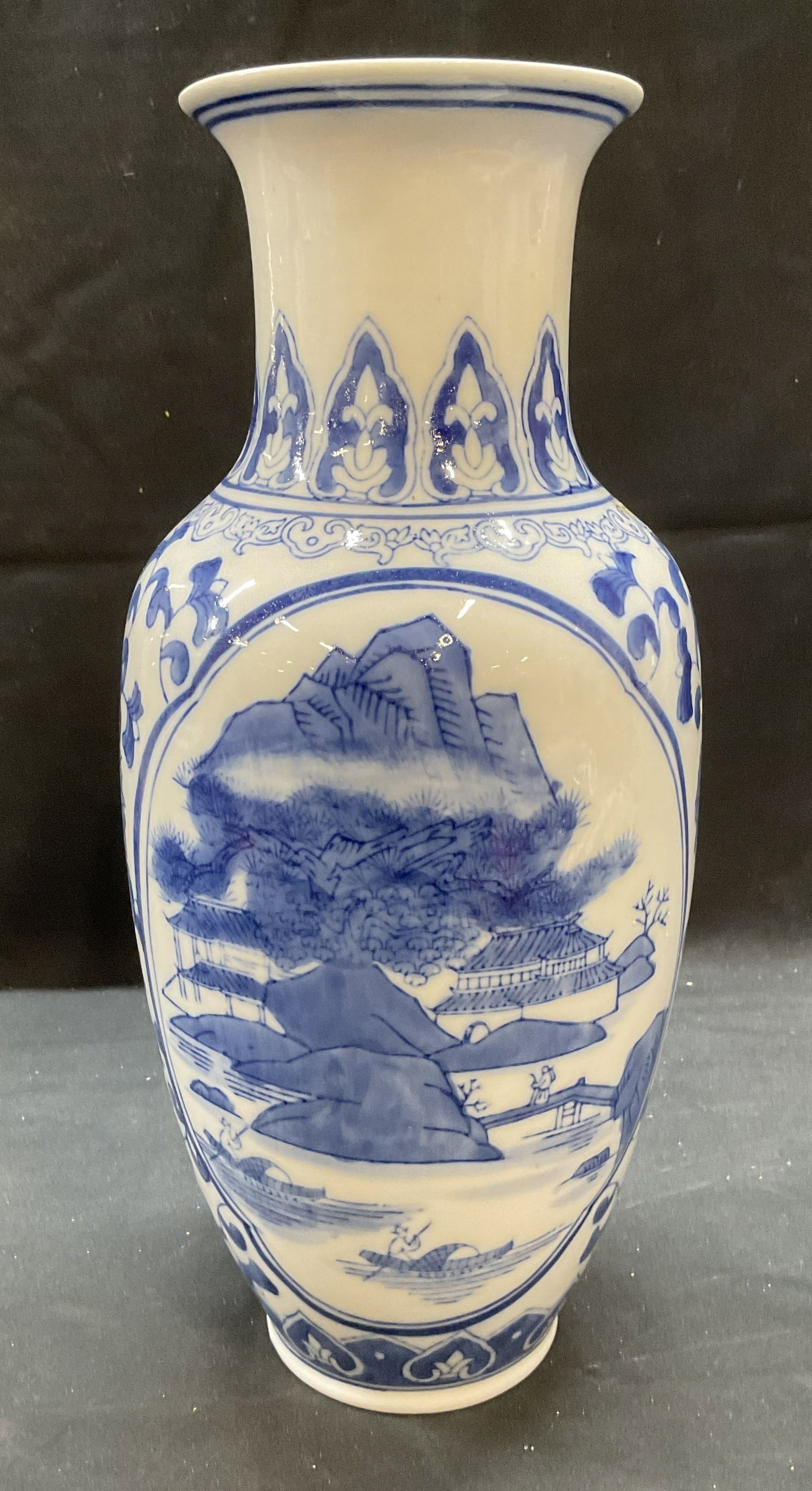 Asian Blue & White Landscape porcelain Vase: Asian blue and white porcelain vase with hand painted mountain and water landscape and floral motif. Measures approx 5 x 12 inches. Some wear including scratching and small chips observed. Vase, Asian