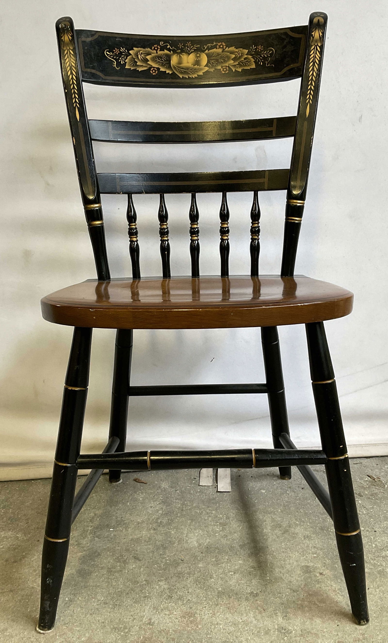 HITCHCOCK Black & Maple Stenciled Chair USA: Hitchcock Black & Maple Stenciled Chair. Features a stenciled detail and gold trim. Stenciled on back of seat L. Hitchcock. Hitchcocks-ville. Conn. Warranted. Measures approx. 34H x 17D x 17W in. Loss
