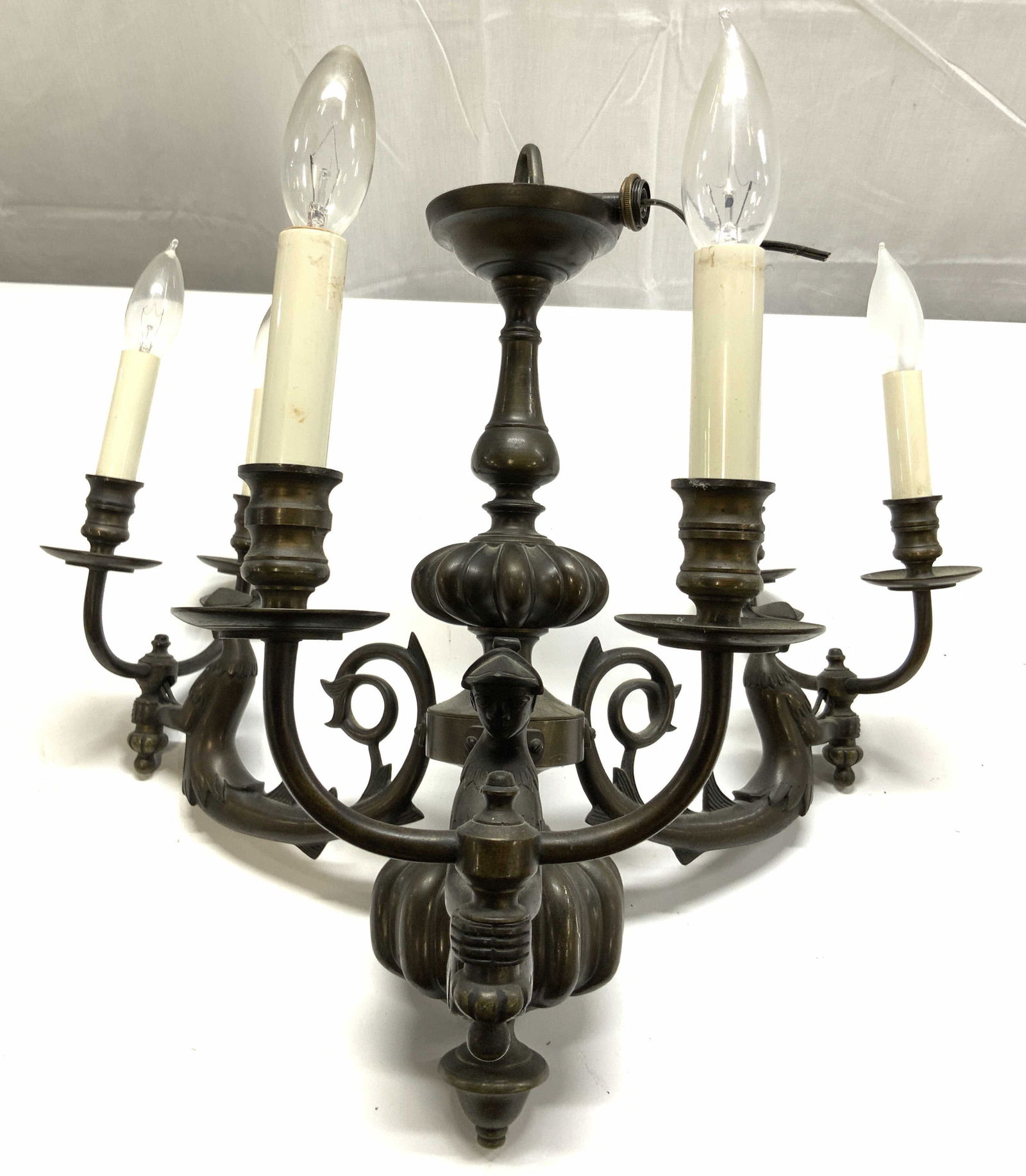Vtg Gilt Metal 3 Arm Mermaid Chandelier: Chandelier is gilt metal possibly bronze. Piece has 3 arms, each of which branch into 2 additional arms, leading to bulb sockets. Chandelier arms have mermaid forms. Piece has candlestick form Bulb so