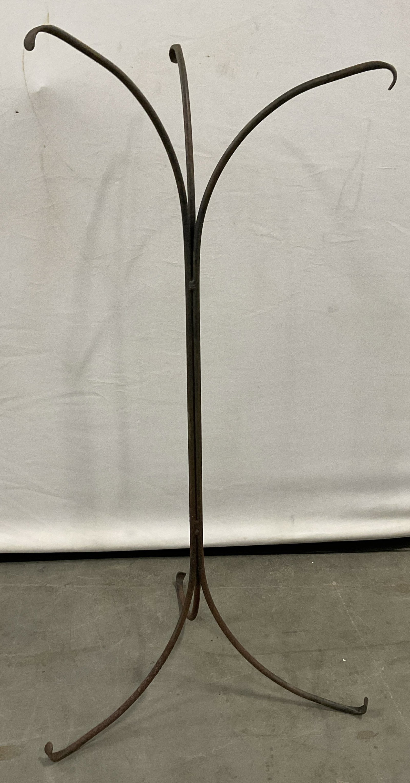 Vintage Iron Curved Arm Plant Stand 37.5in H: Vintage Iron Curved Arm Plant Stand. Crafted from metal, appears to be iron. Curved arms and legs. Width at base measures approx. 18.25 inches. Width at top measures approx. 16.5 inches. Height measur