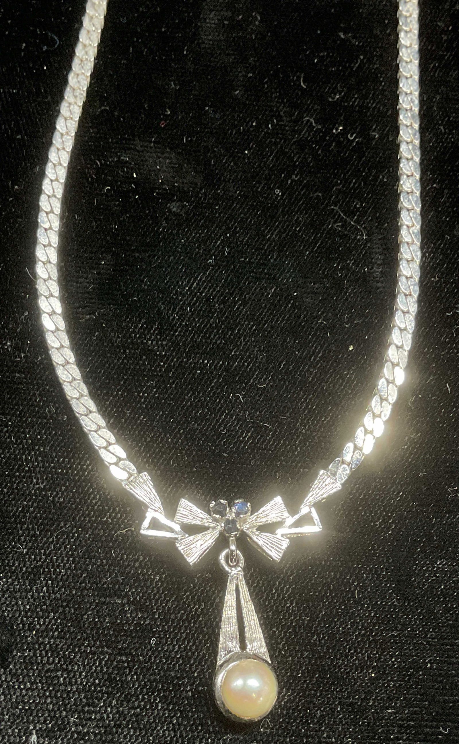 Vtg 835 Silver Topaz, Pearl Pendant Necklace: Vintage 835 silver necklace with bow and drop motif pendant with topaz and pearl accents. Marked 835. Drop length approx 8 inches. Total weight 15.6 grams. Some wear including scratching observed. Jew