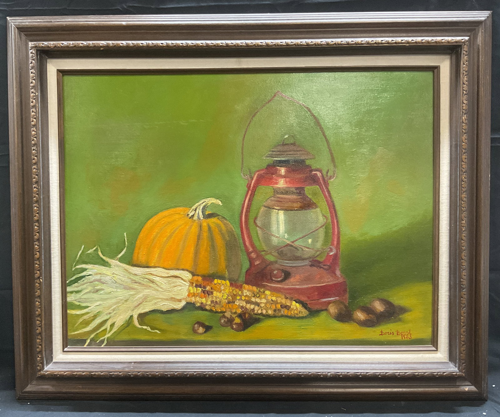 Doris Borst Still Life Autumn Lantern Oil Painting: Framed and signed oil painting by Doris Borst. Signed and dated at lower right, 1985. Autumn still life scene with pumpkin, corn, chestnuts, and lantern with green background. Framed in wood frame. No