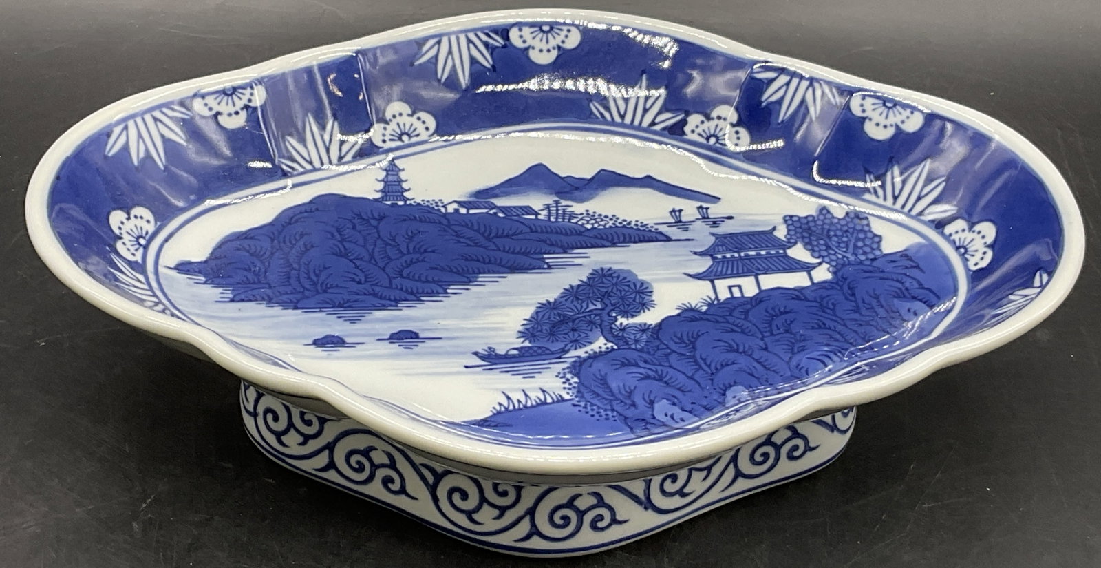 Signed Asian Blue & White Porcelain Pedestal Bowl: Signed Asian Blue & White Porcelain Pedestal Bowl. Lozenge form. Florals, geometric patterns, buildings, and foliage motifs throughout. Underside is signed with Asian characters. Measures approx. 3H x