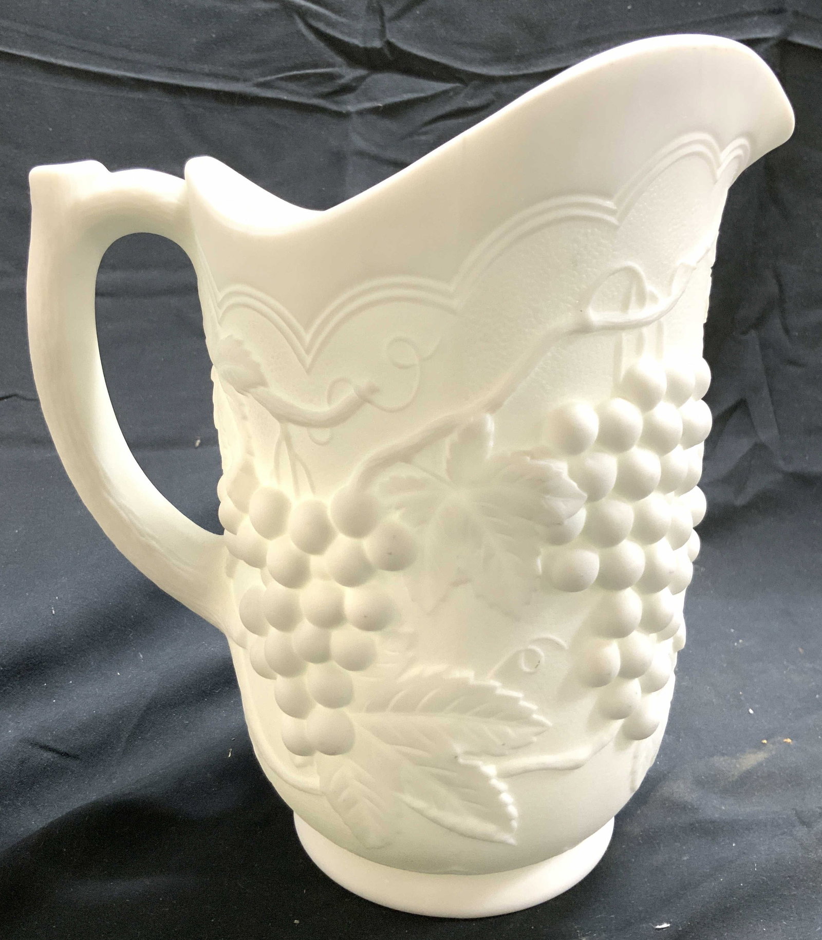 Vntg IMPERIAL Opaque Milk Glass Pitcher: Pitcher appears to be IMPERIAL (No apparent markings). Pitcher is white toned milk glass. Pitcher has beveled grape, vine & leaf detail. Piece is opaque. Pitcher measures approximately 8.5 inches tall