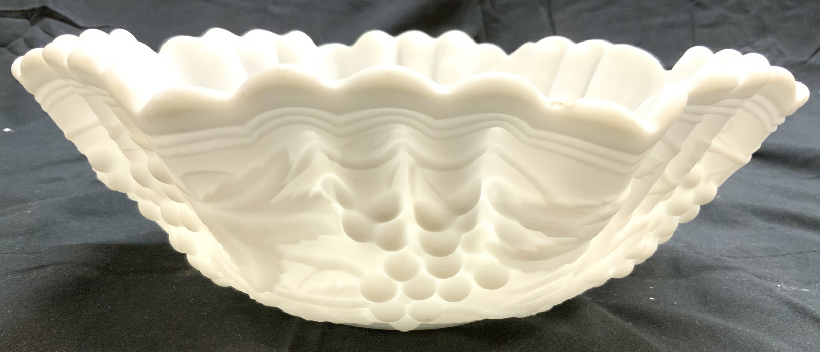 Vntg IMPERIAL Opaque Milk Gls Handkerchief Bowl: Bowl appears to be IMPERIAL (No apparent markings). Bowl is white toned milk glass. Bowl has beveled grape, vine & leaf detail. Piece is opaque. Bowl 9.5 inches wide 3.5 inches tall. Piece measures ap
