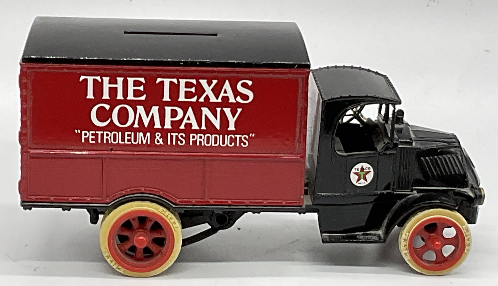 THE ERTL USA Vintage Diecast Truck Coin Bank: Vintage diecast coin bank shaped like a 1925 Mack Bulldog truck, advertising The Texas Company (Texaco). Crafted from metal and plastic materials. Underside is marked THE ERTL, DYERSVILLE IOWA USE, MA