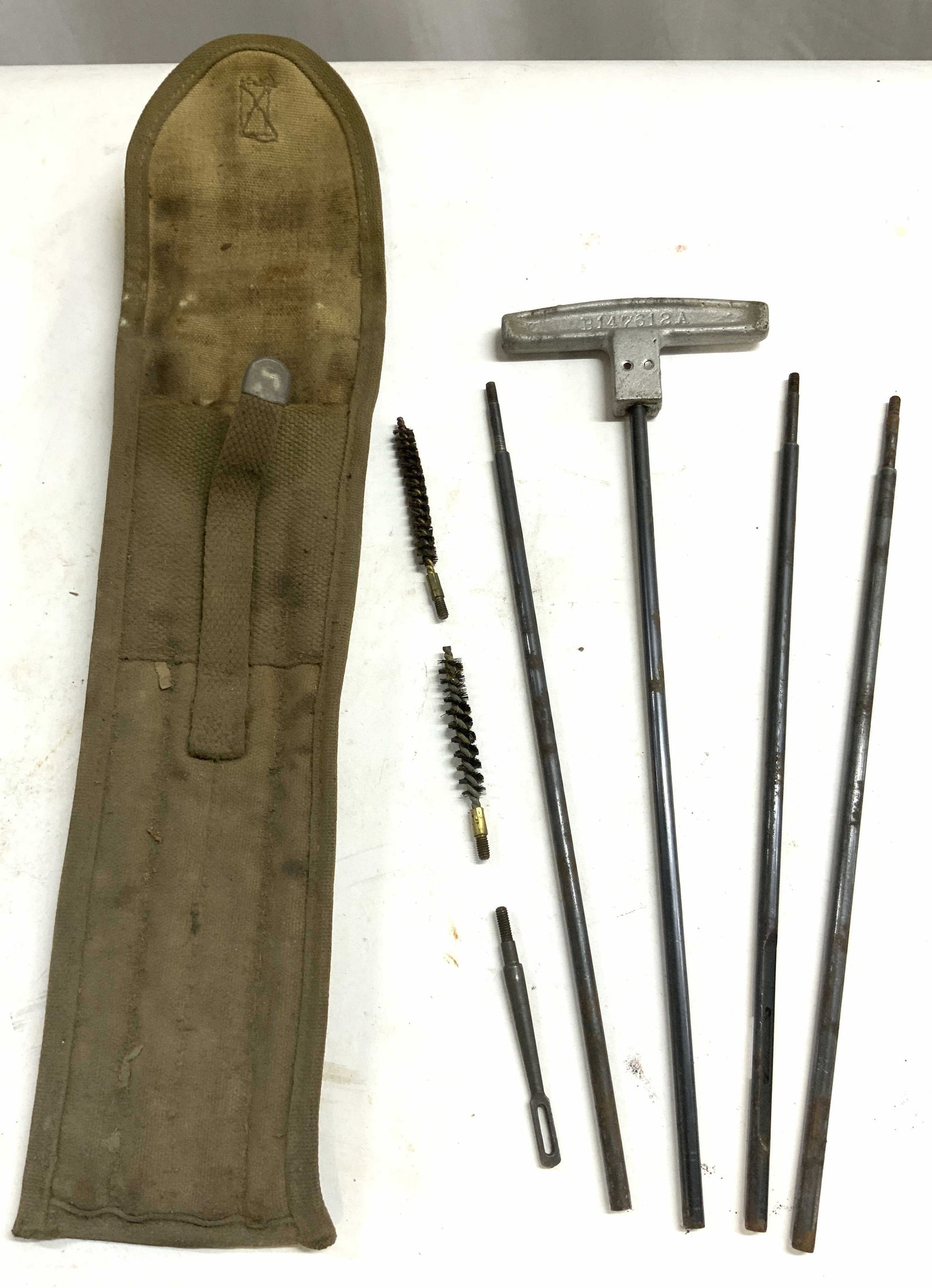 WW2 Vntg Rod Cleaning Case & Tools: Militaria, military collectibles. Lot includes rod cleaning case, 4 gun cleaning rods & 2 Hndls cleaning brushes. Rod cleaning case has dark sand tone with flap lid. Cleaning rods are each metal. Case