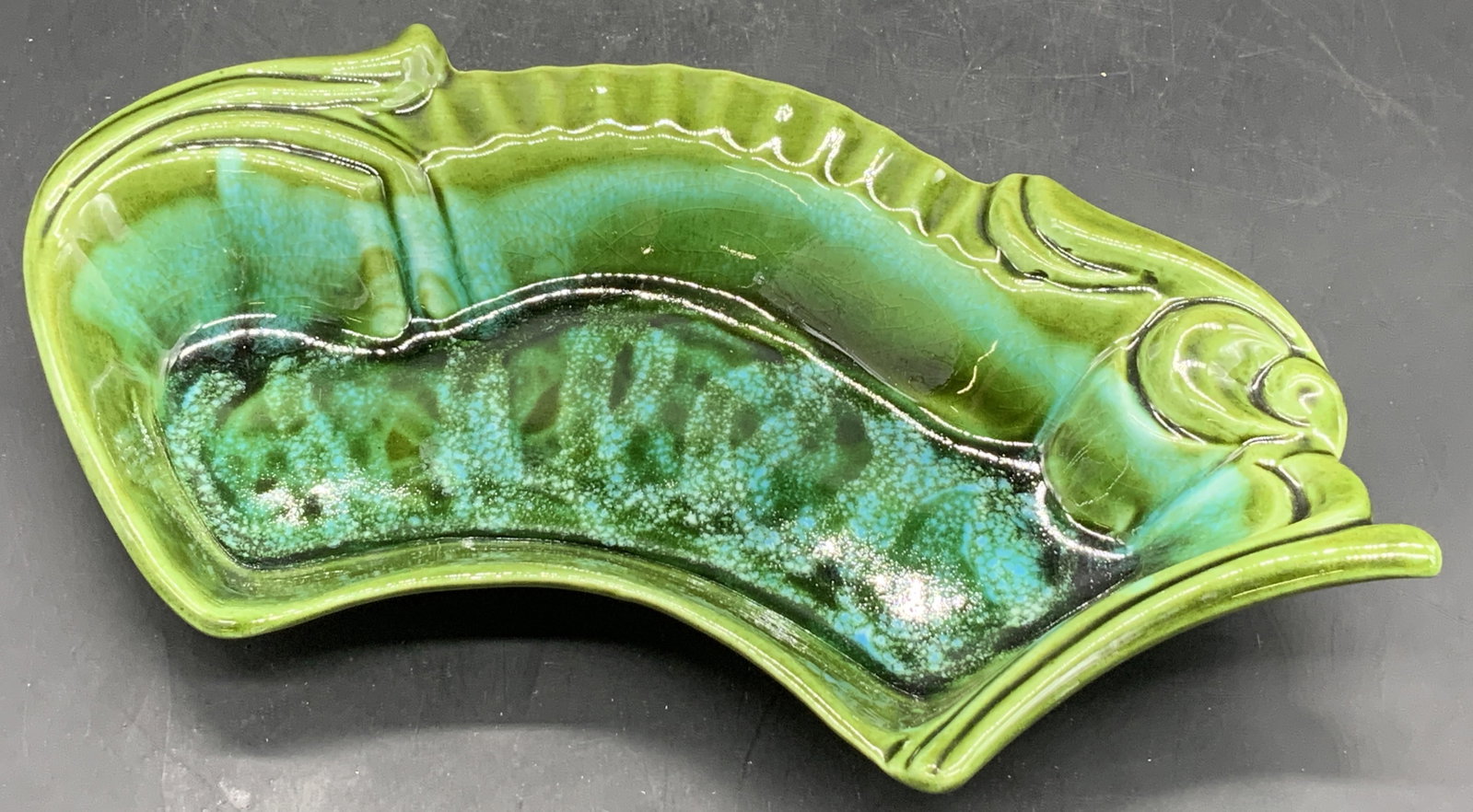 MAURICE CALIFORNIA POTTERY USA Glazed Trinket Dish: Vintage MAURICE CALIFORNIA POTTERY USA Glazed Trinket Dish. Primarily green and blue hues. Measures approx. 2H x 10.5W in. Underside signed MAURICE OF CALIF USA. Chipping, crazing, and discoloration p
