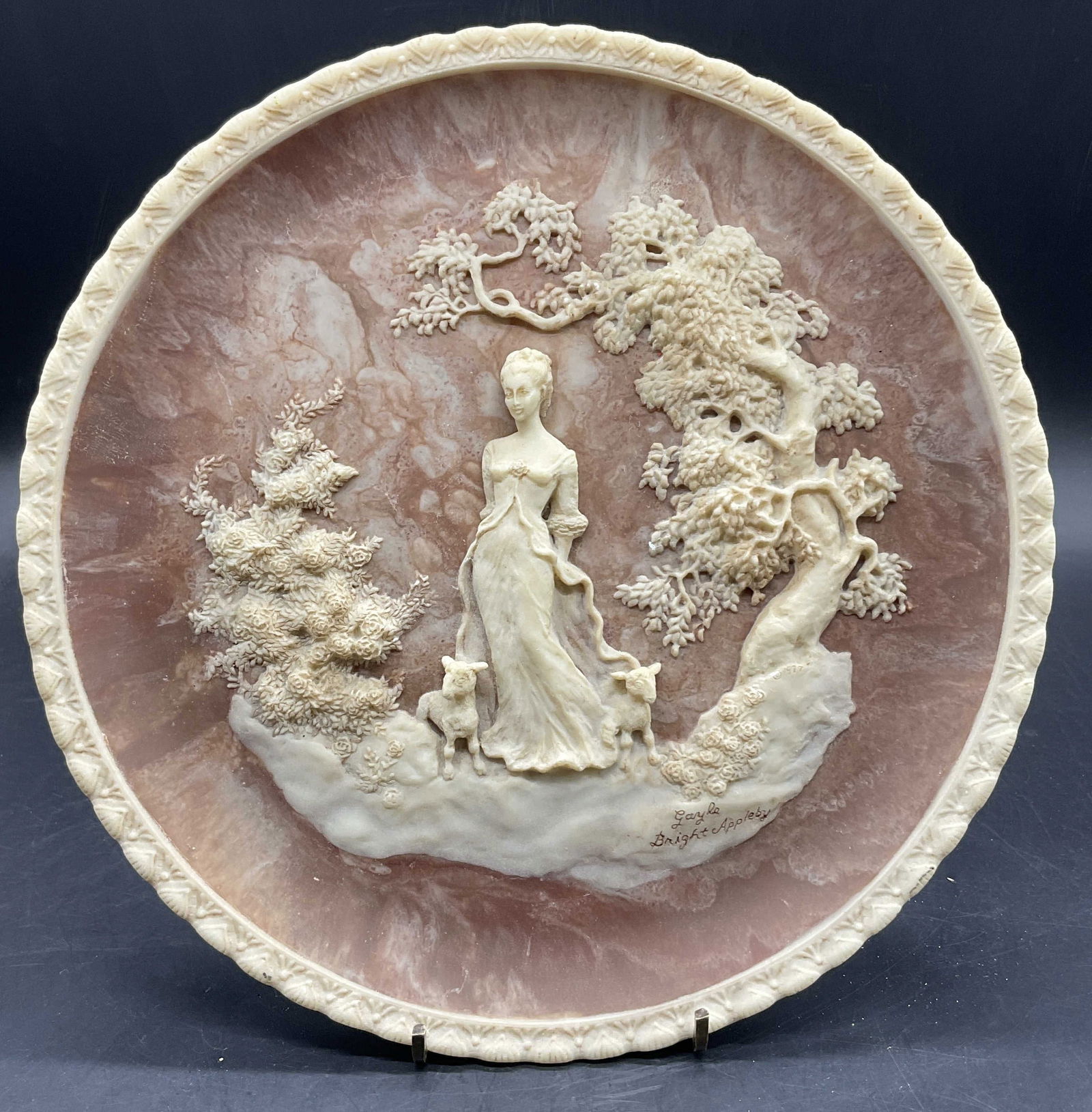 INCOLAY STUDIOS SHE WALKS IN BEAUTY Plate: INCOLAY STUDIOS SHE WALKS IN BEAUTY Plate. Raised female figural to the obverse depicted in a nature setting with lambs. Underside reads: Plate no. 36264, She Walks in Beauty, (Lord Byron), Sculptured