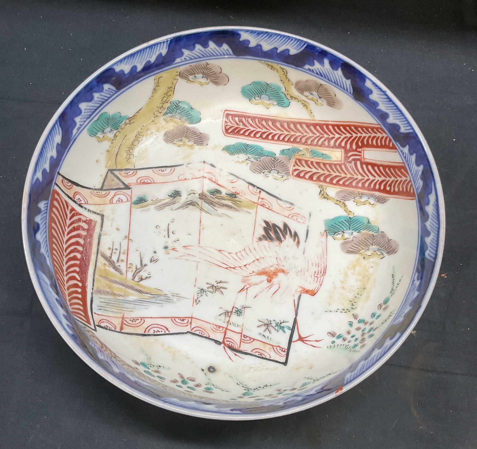 Vintage Asian Hand Painted Porcelain Bowl: Vintage hand painted Asian porcelain bowl. Interior scene with cranes. Red and blue. Measures approx 9.5 x 3.5 inches. Wear including loss to paint and scratching. Asian bowl, Asian porcelain bowl, po