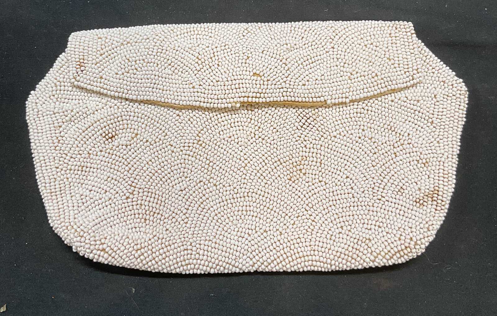 Vtg Jorelle Bags White Beaded Clutch, Belgium: Vintage Jorelle Bags white beaded satin clutch bag. Signed on interior. Made in Belgium. Measures approx 4.5 x 8 inches. Wear including blemishes and loss to beading. Jorelle bags, Jorelle bags clutch
