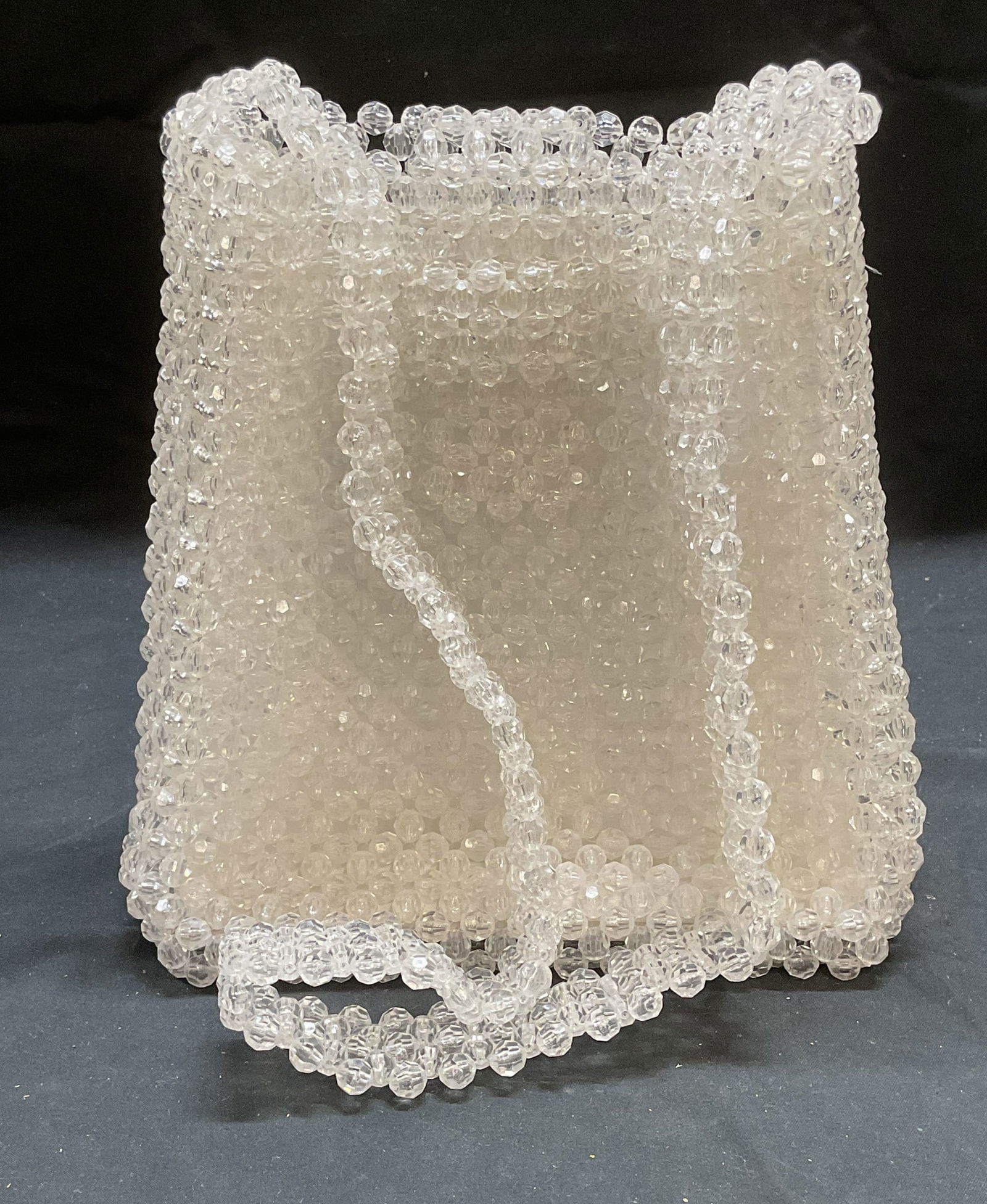 Colorless Clear Crystal Beaded Handbag: Colorless clear crystal beaded handbag with tab closure and interior lining. Measures approx 7 x 4 x 7.75 inches. Some wear including scratching and blemishes to lining. Crystal beaded handbag, beaded