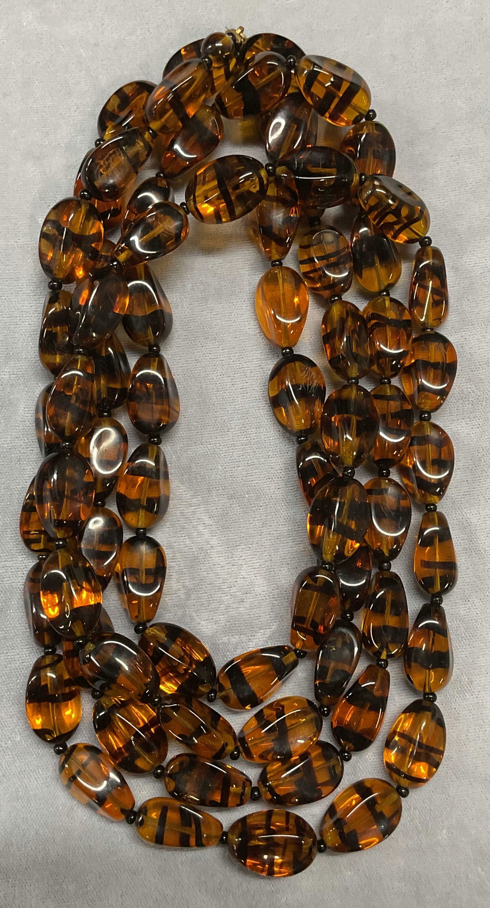 Vtg Amber & Black Glass Beaded Necklace, 30 In: Vintage Amber and black banded glass beaded necklace. Drop length approx 30 inches. Some wear including scratching observed. Jewelry, estate jewelry, costume jewelry, cocktail jewelry, fashion jewelry