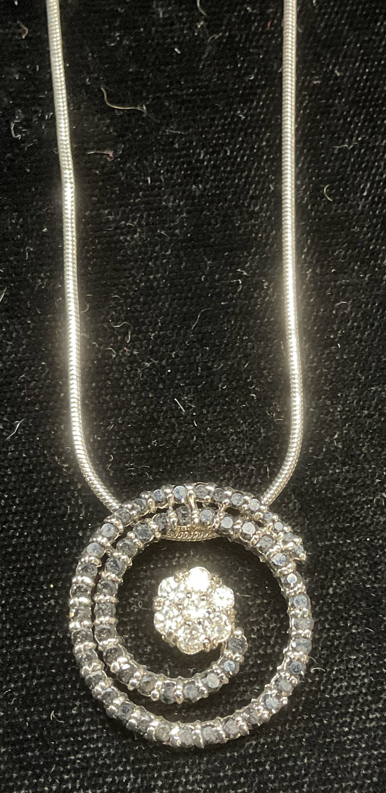 Kian Family Silver Ton Crystal Pendant Necklace: Kian Family silver tone pendant necklace with crystal swirl and flower pendant. Signed on hang tag. Drop length approx 9 inches. Some wear including scratching observed. Jewelry, estate jewelry, costu