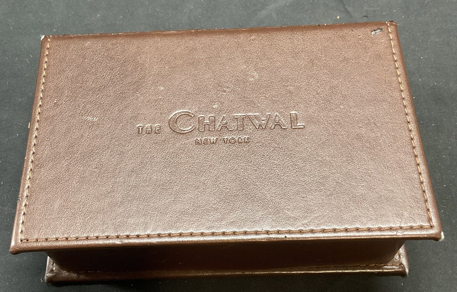 Chatwal Hotel NYC Brown Leather Jewelry Box: The Chatwal Hotel, New York City, brown leather jewelry box. Two compartments. Felt lining. Measures approx 7 x 4.5 x 2 inches. Some wear consistent with exposure, see photographs. Chatwal hotel, Chat