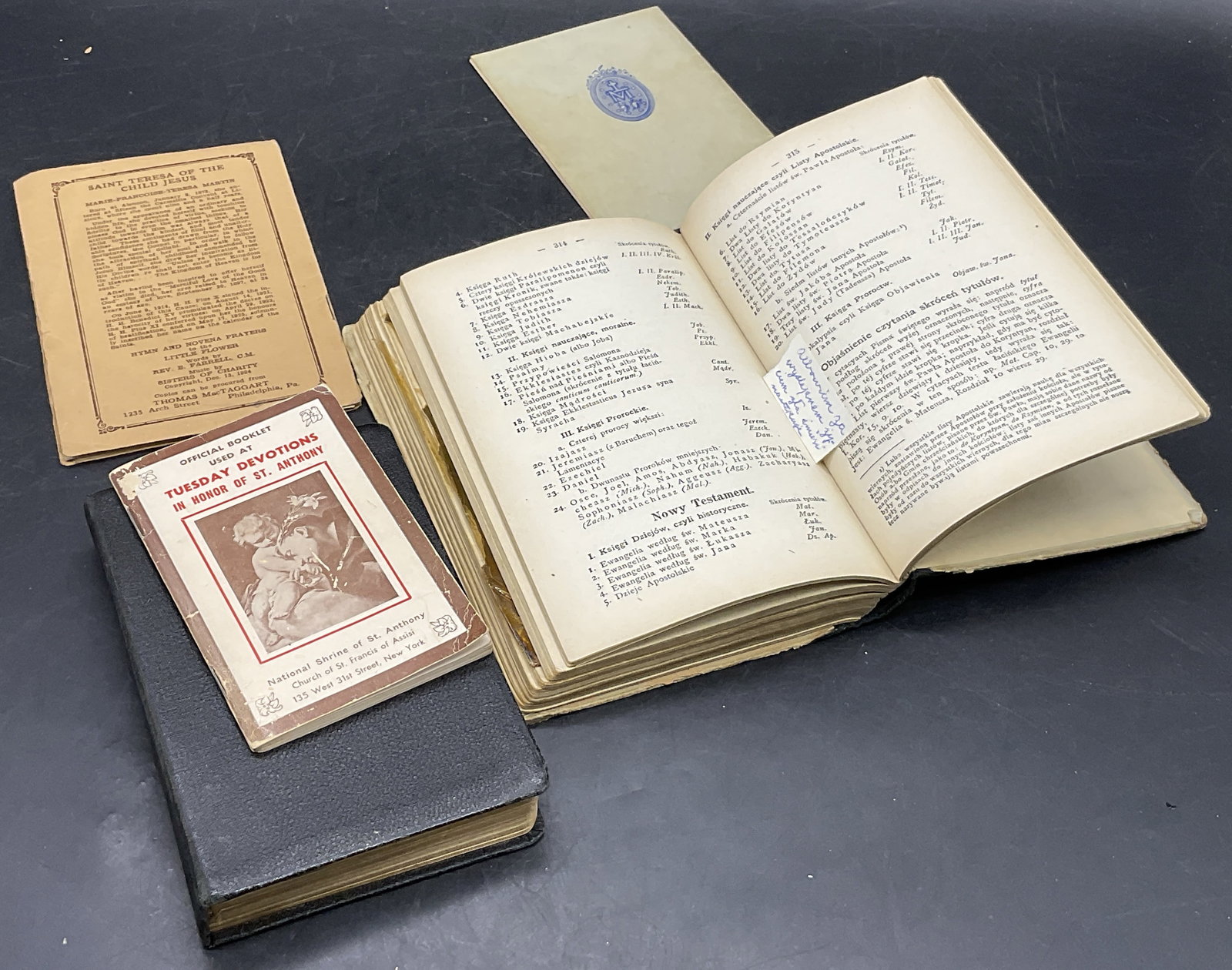 Lot 5 Vintage Religious Books & Pamphlets, 1927+: The lot includes Official Booklet Used At Tuesday Devotions in Honor of Saint Anthony, The Perpetual Novena, Novena and Triduum Prayers to the Most Holy Trinity, and two hardcover books in a foreign l