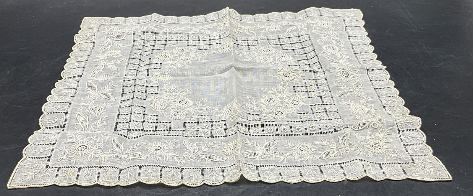 Vintage Floral Embroidery Linen Handkerchief: Vintage Floral Embroidery Linen Handkerchief. Pierced fabric work details as well. Off white hue. Measures approx. 11.25L x 11.25W in. Discoloration and surface wear present. No material tag, appears