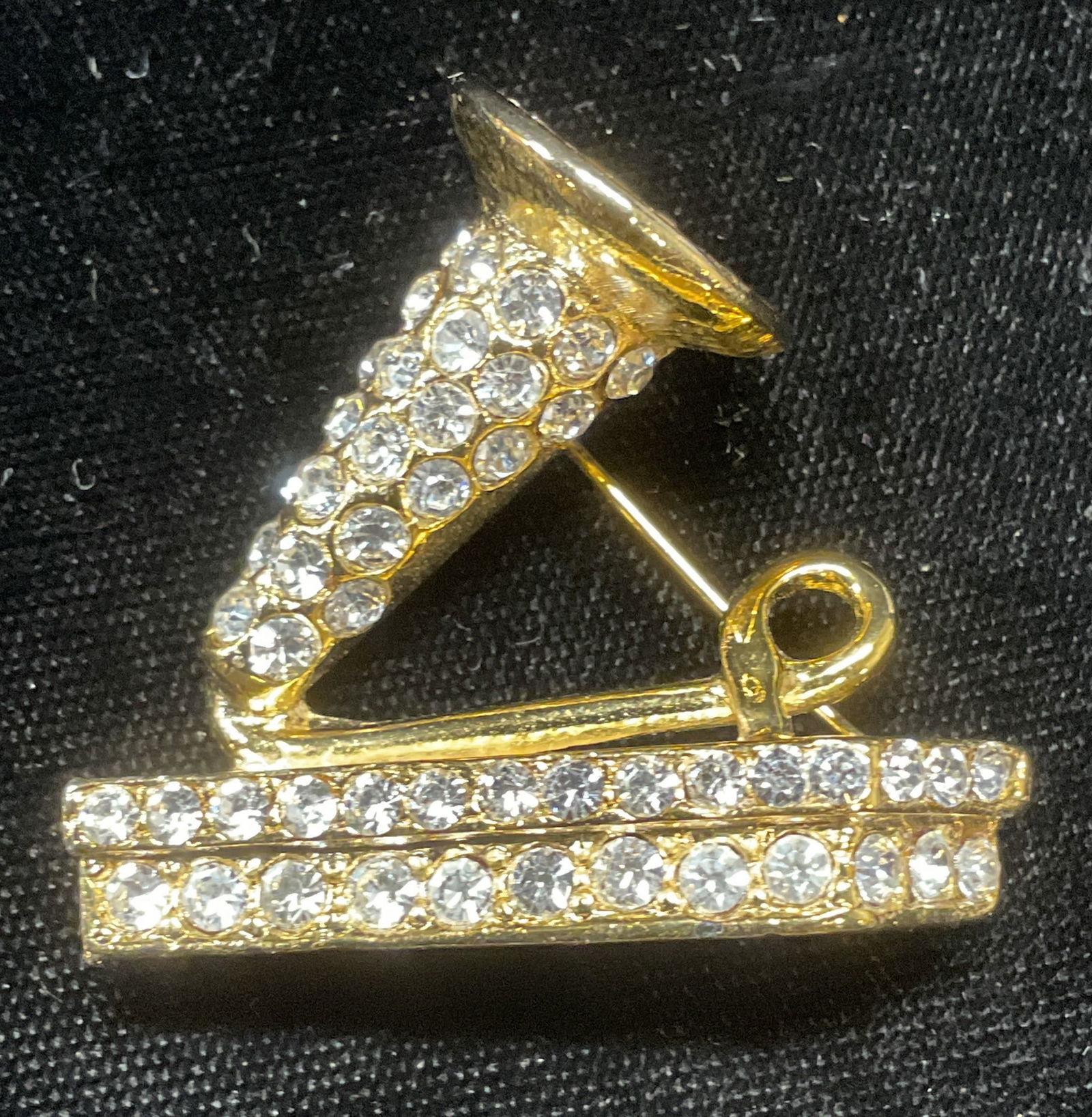 Gold Tone Crystal Gramophone Brooch: Gold tone colorless crystal gramophone motif brooch. Measures approx 1.25 x 1.5 inches. Some wear including scratching observed. Jewelry, estate jewelry, costume jewelry, cocktail jewelry, fashion jew