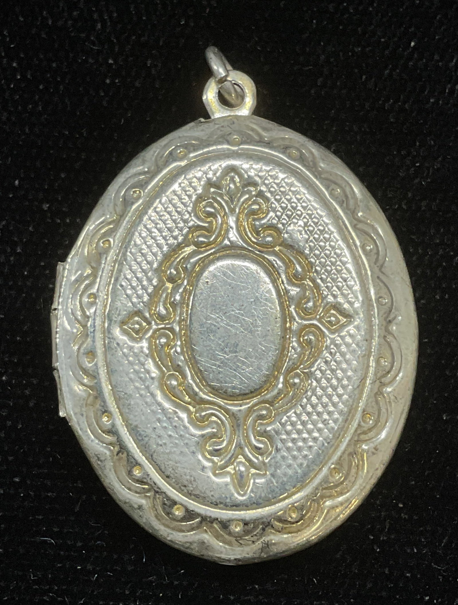 Vintage Silver Tone Locket Pendant: Vintage silver tone locket pendant with scroll design. Measures approx 1.25 x 1 inches. Some wear including scratching observed. Jewelry, estate jewelry, costume jewelry, cocktail jewelry, fashion jew