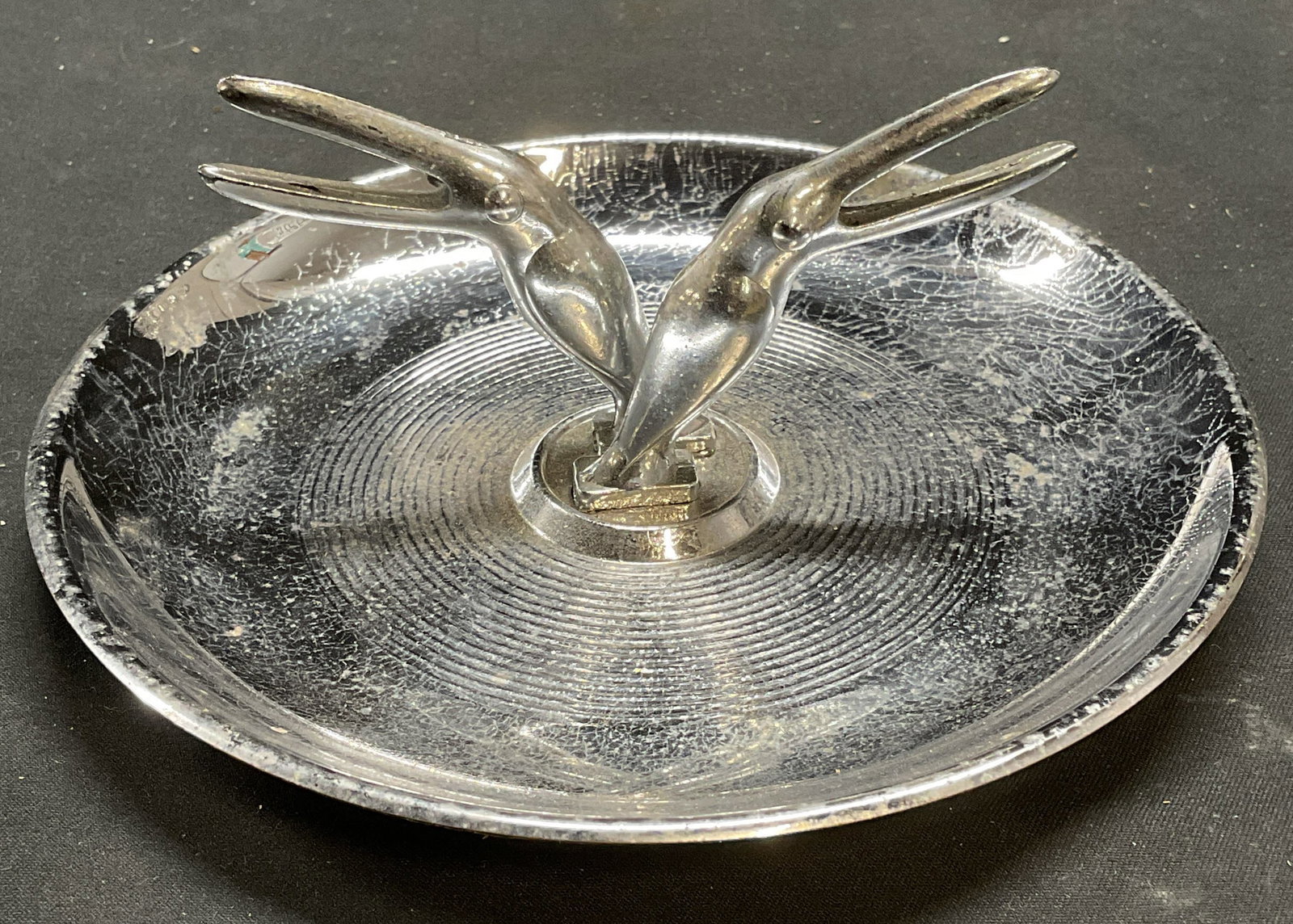 Vtg Silver Tone Chrome Toucan Trinket Dish: Vintage silver tone chrome Toucan motif trinket dish/ashtray. Patent label on underside. Circa mid 20th century, Art Deco design. Measures approx 5.75 x 2.5 inches. Wear including scratching observed.