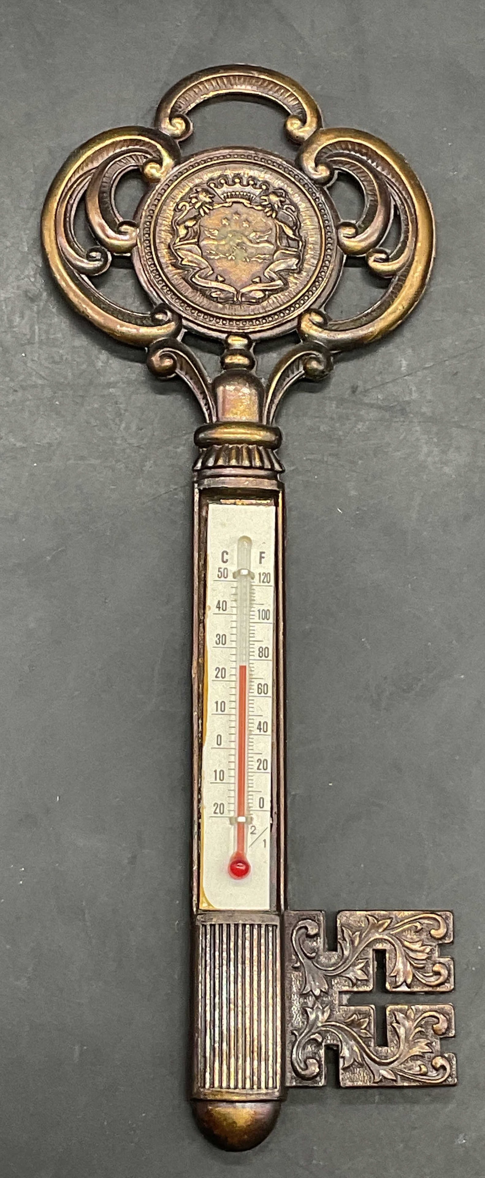 Vintage Metal Key Form Thermometer Japan: Vintage Metal Key Form Thermometer. Crafted from copper toned metal. Measures approx. 8L x 3W in. Reverse reads MADE IN JAPAN. Thermometer is not attached. Surface wear consistent with age, use, and e
